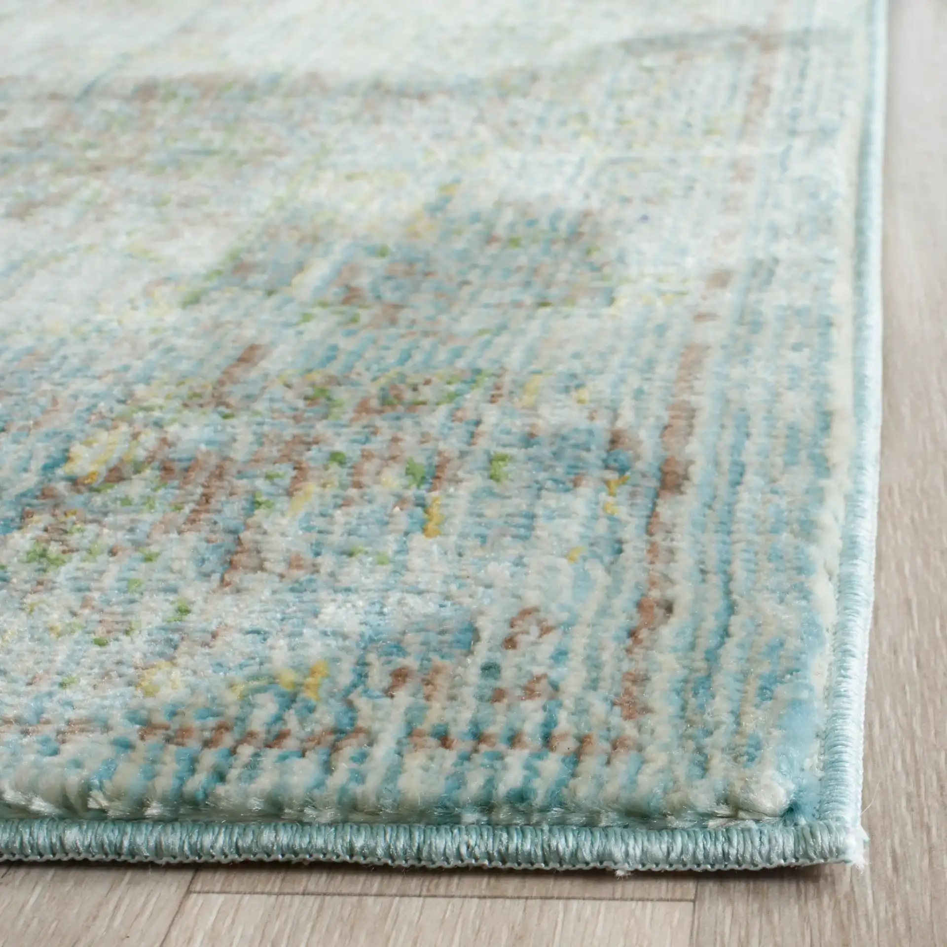 Valencia Floral Scroll Bordered Rug in Light Blue / Turquoise in a styled room