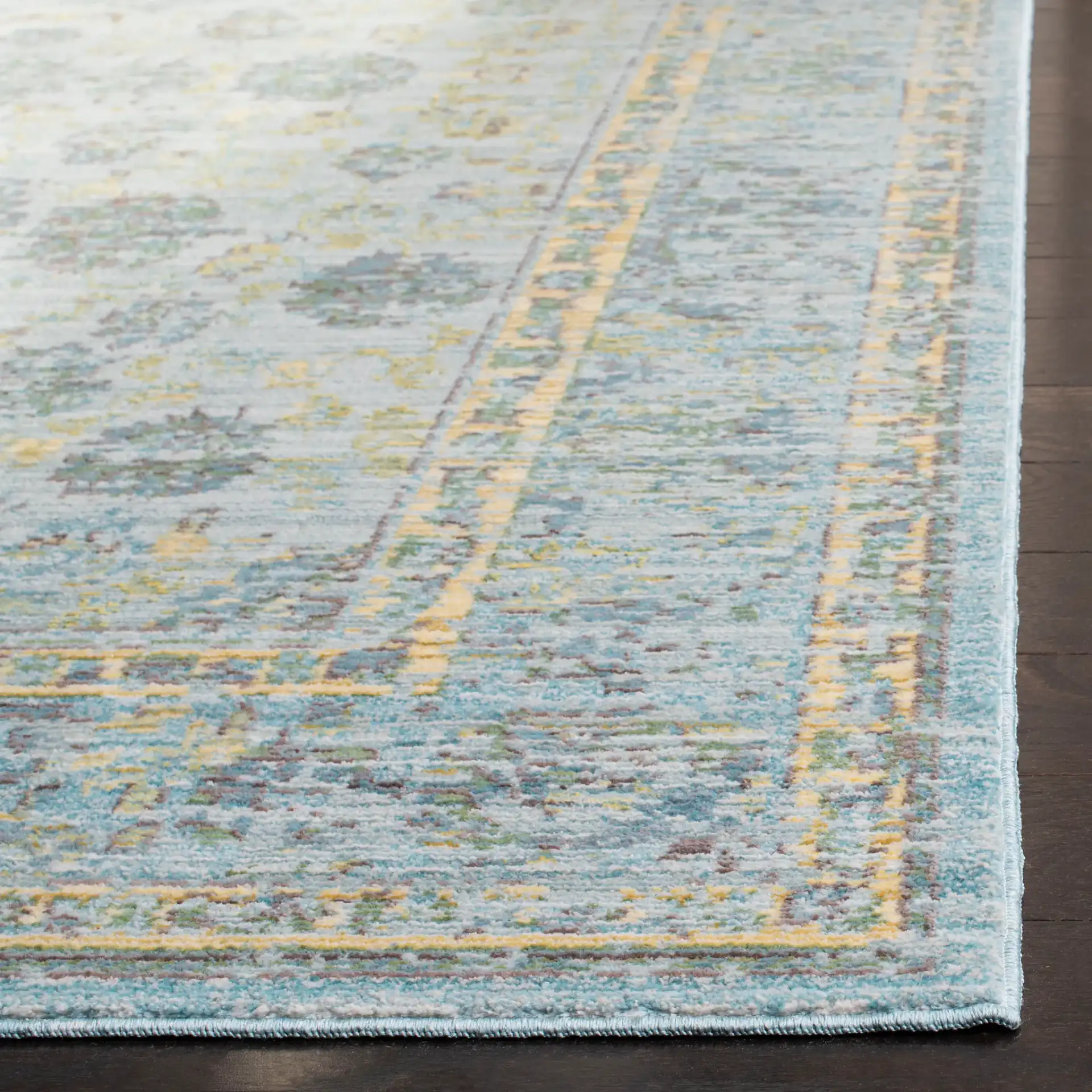 Valencia Floral Scroll Bordered Rug in Light Blue / Turquoise in a styled room