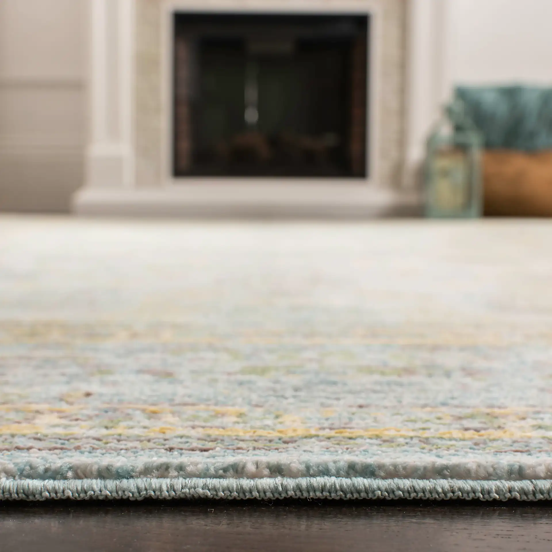 Valencia Floral Scroll Bordered Rug in Light Blue / Turquoise in a styled room