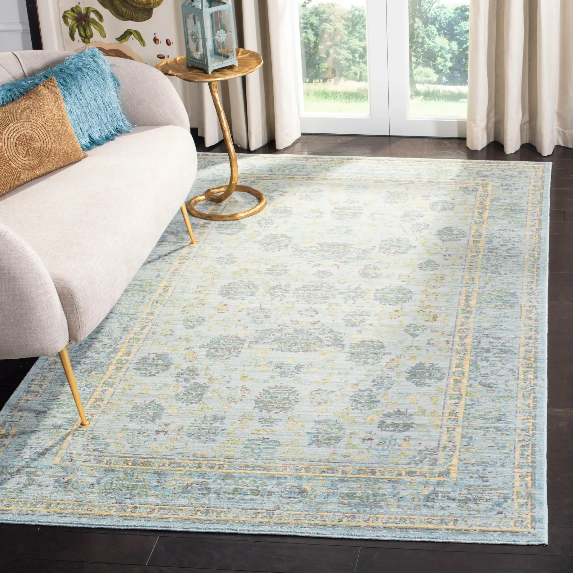 Valencia Floral Scroll Bordered Rug in Light Blue / Turquoise in a styled room