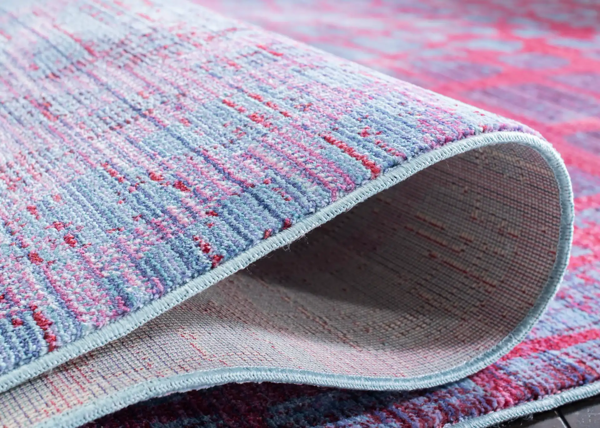 Valencia Cellular Abstract Rug in Blue / Fuchsia in a styled room
