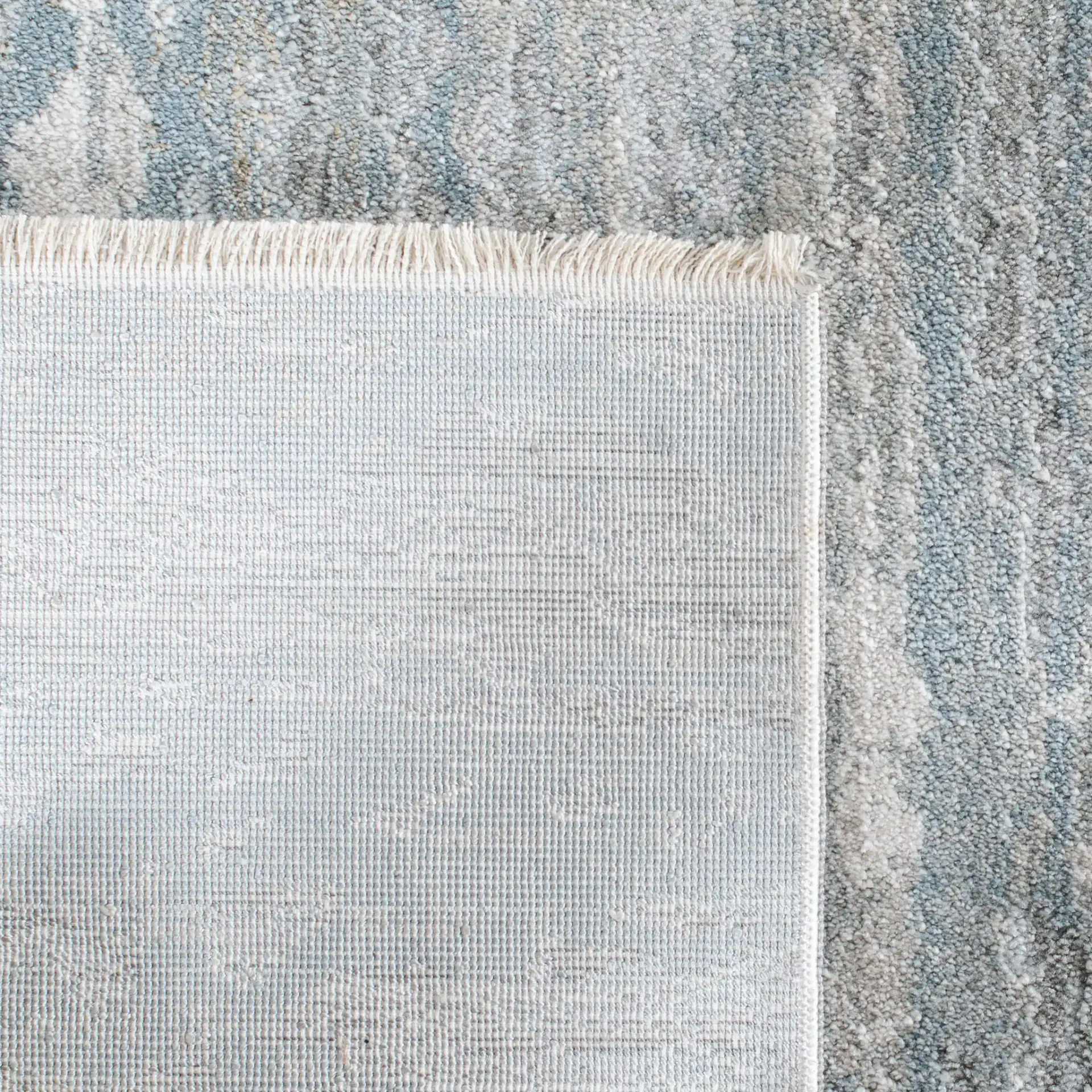 Valencia Allover Abstract Rug in Light Gray / Blue in a styled room