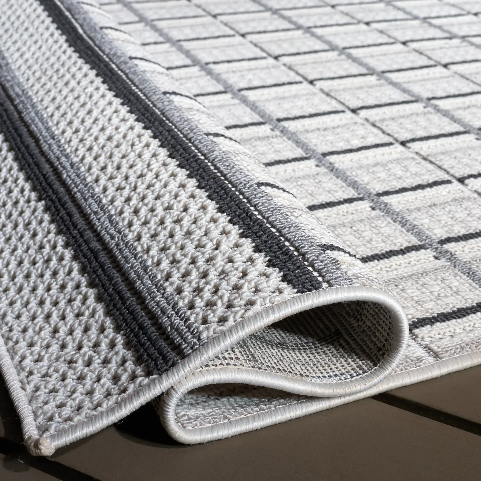 Veranda Grid Rug in Gray / Dark Gray in a styled room