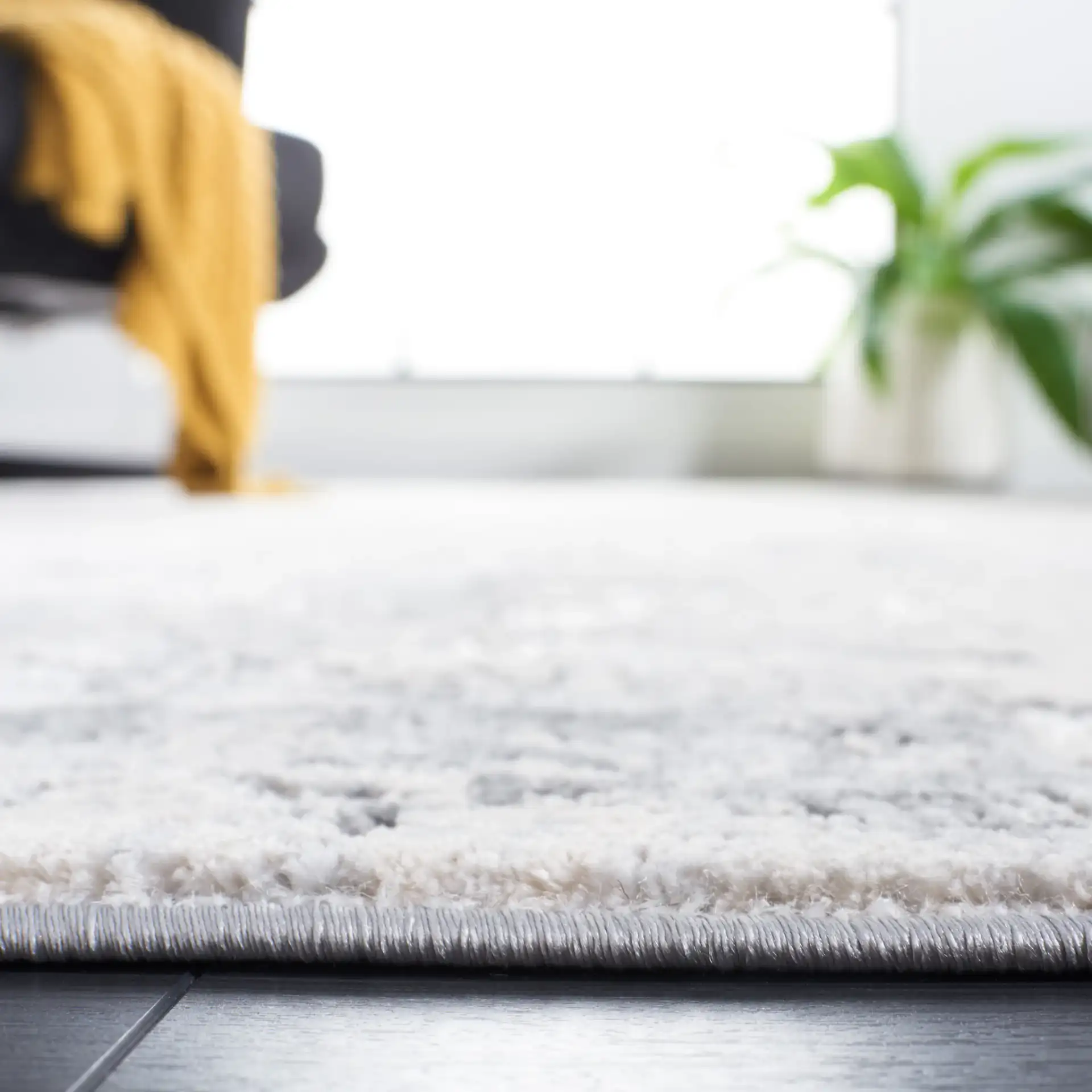 Vogue Weathered Abstract Rug in Gray / Light Gray in a styled room