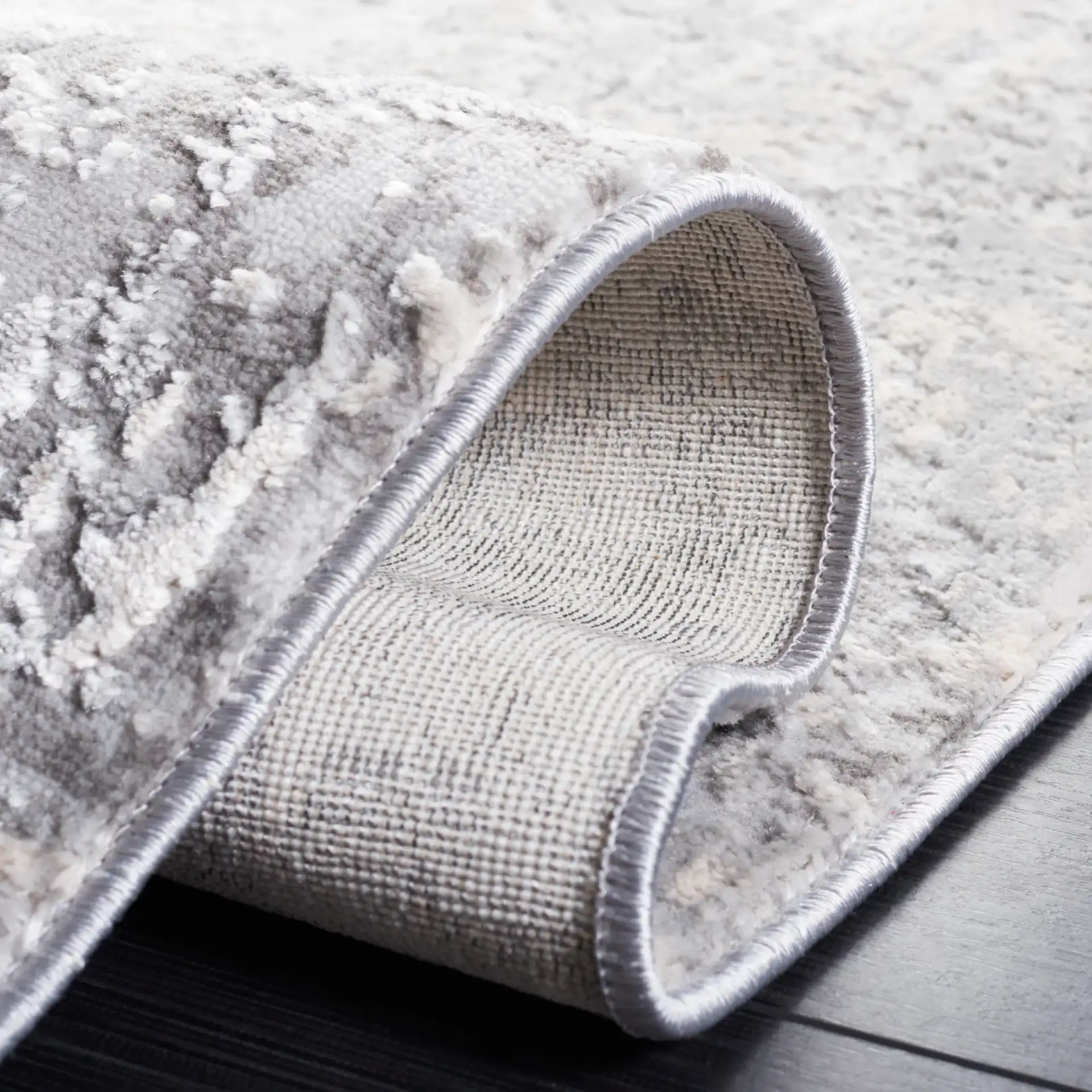 Vogue Weathered Abstract Rug in Gray / Light Gray in a styled room