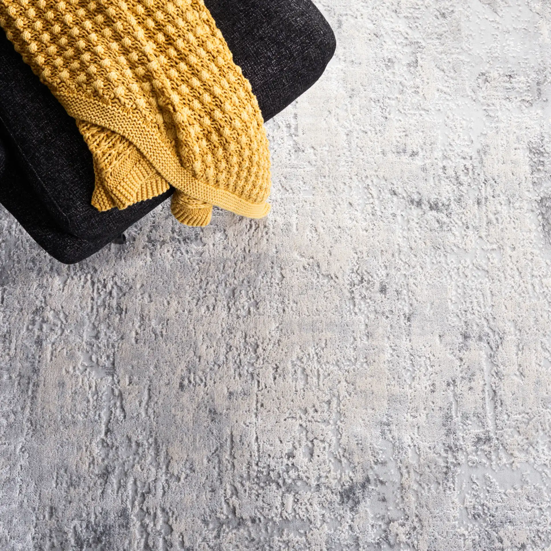 Vogue Weathered Abstract Rug in Gray / Light Gray in a styled room