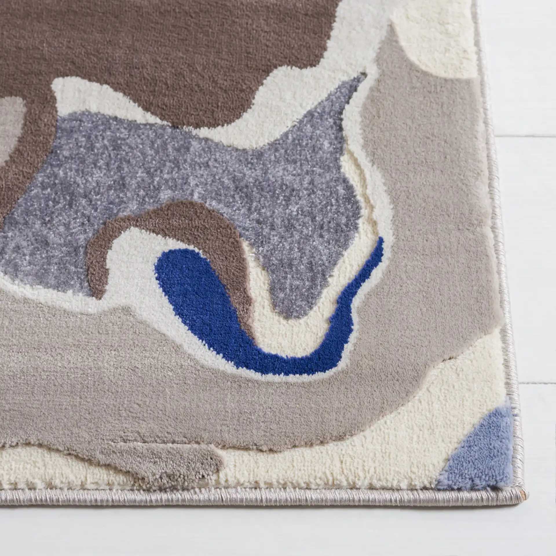 Vogue Fluid Wave Rug in Taupe / Blue in a styled room