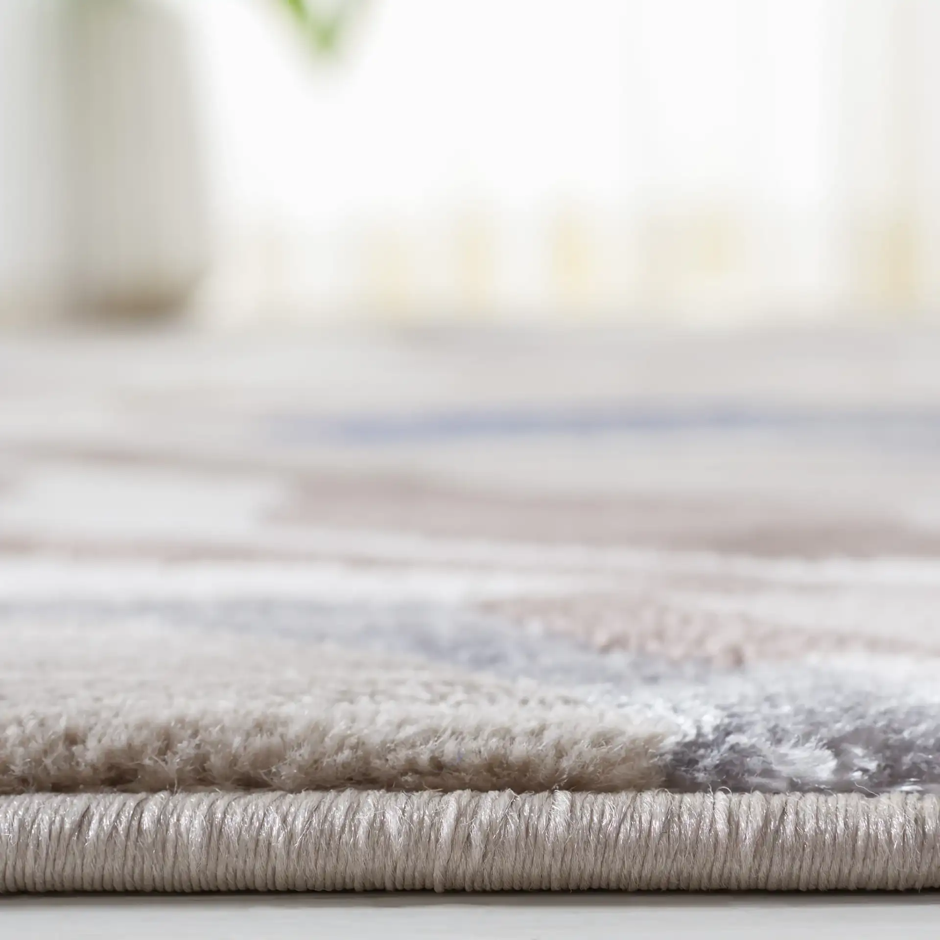 Vogue Fluid Wave Rug in Taupe / Blue in a styled room