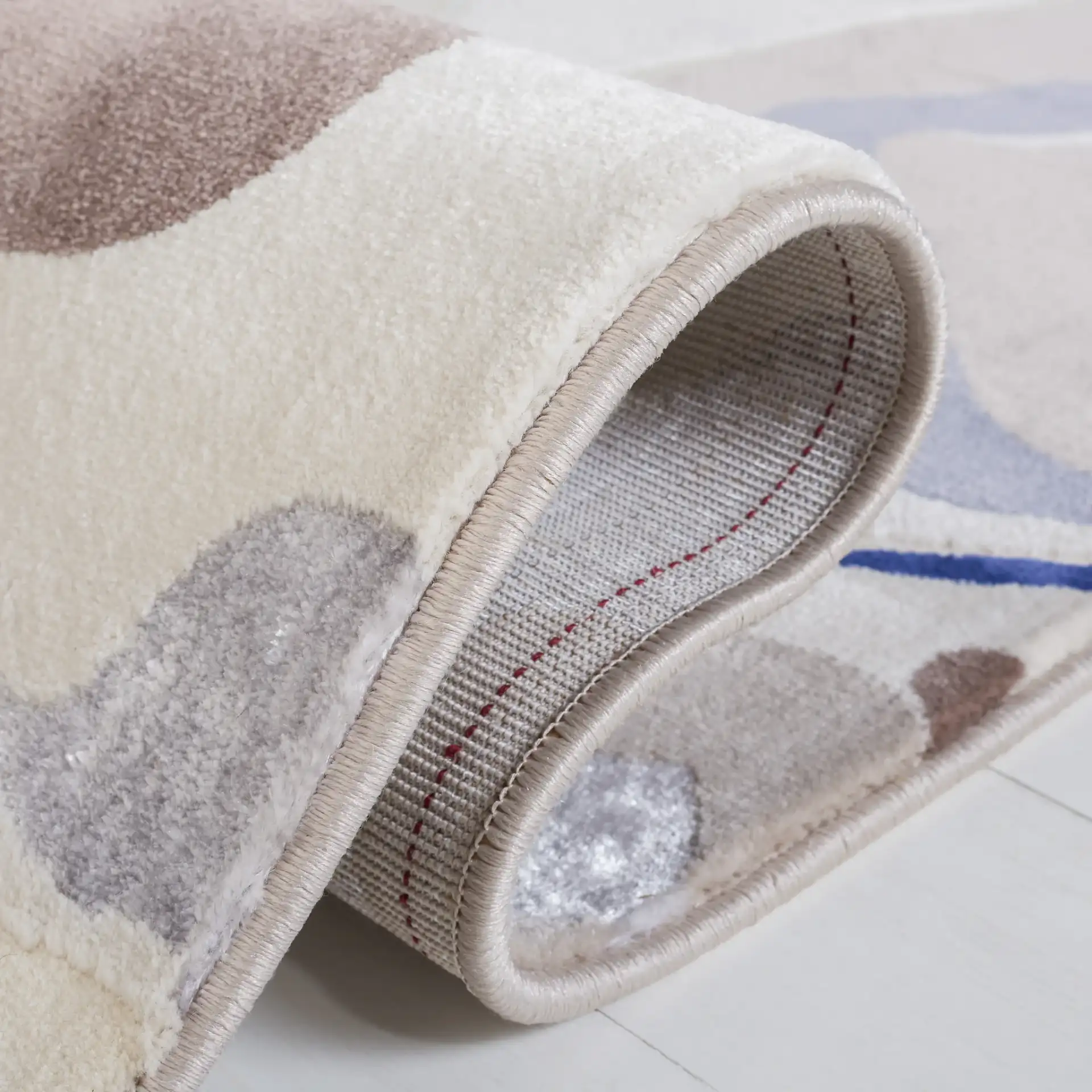 Vogue Fluid Wave Rug in Taupe / Blue in a styled room