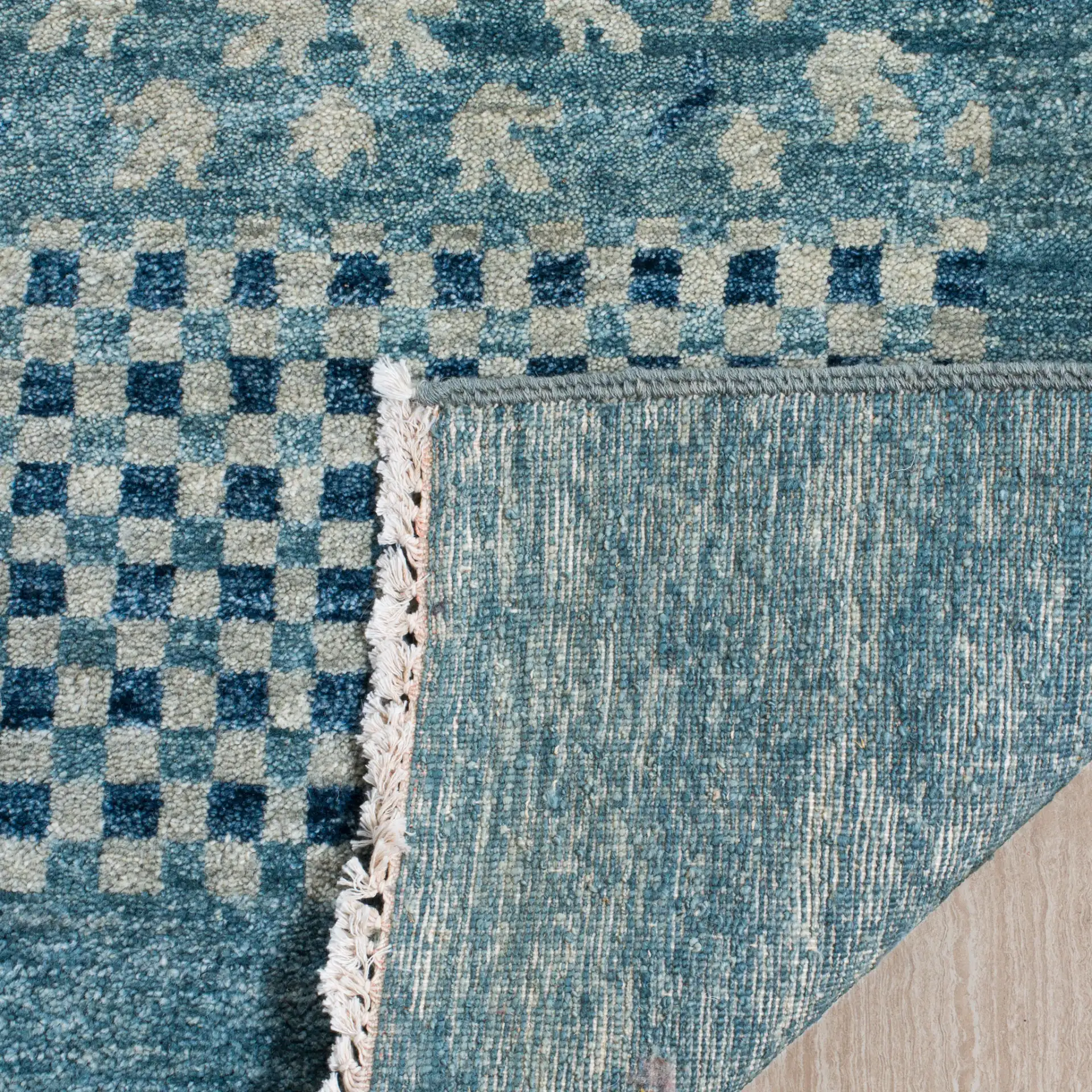 Vineyard Banded Checkerboard Wool Rug in Blue in a styled room