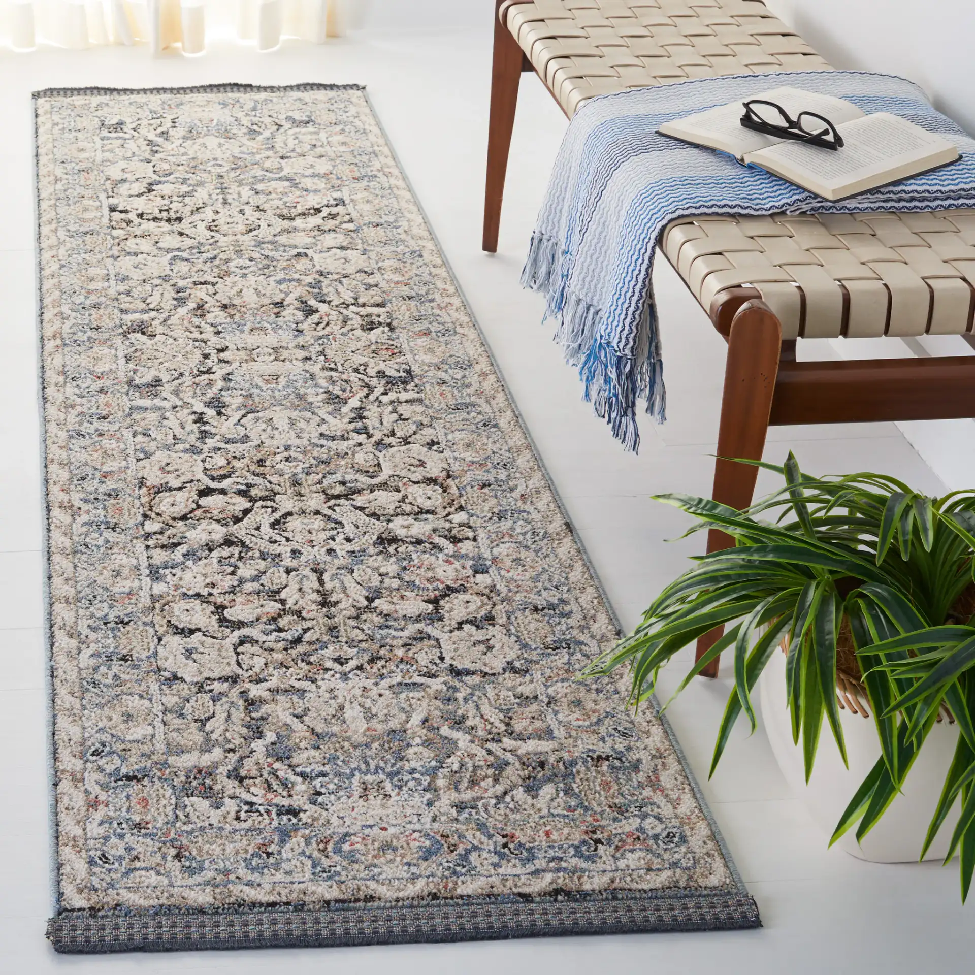 Vivaldi Bordered Floral Rug in Navy / Ivory in a styled room