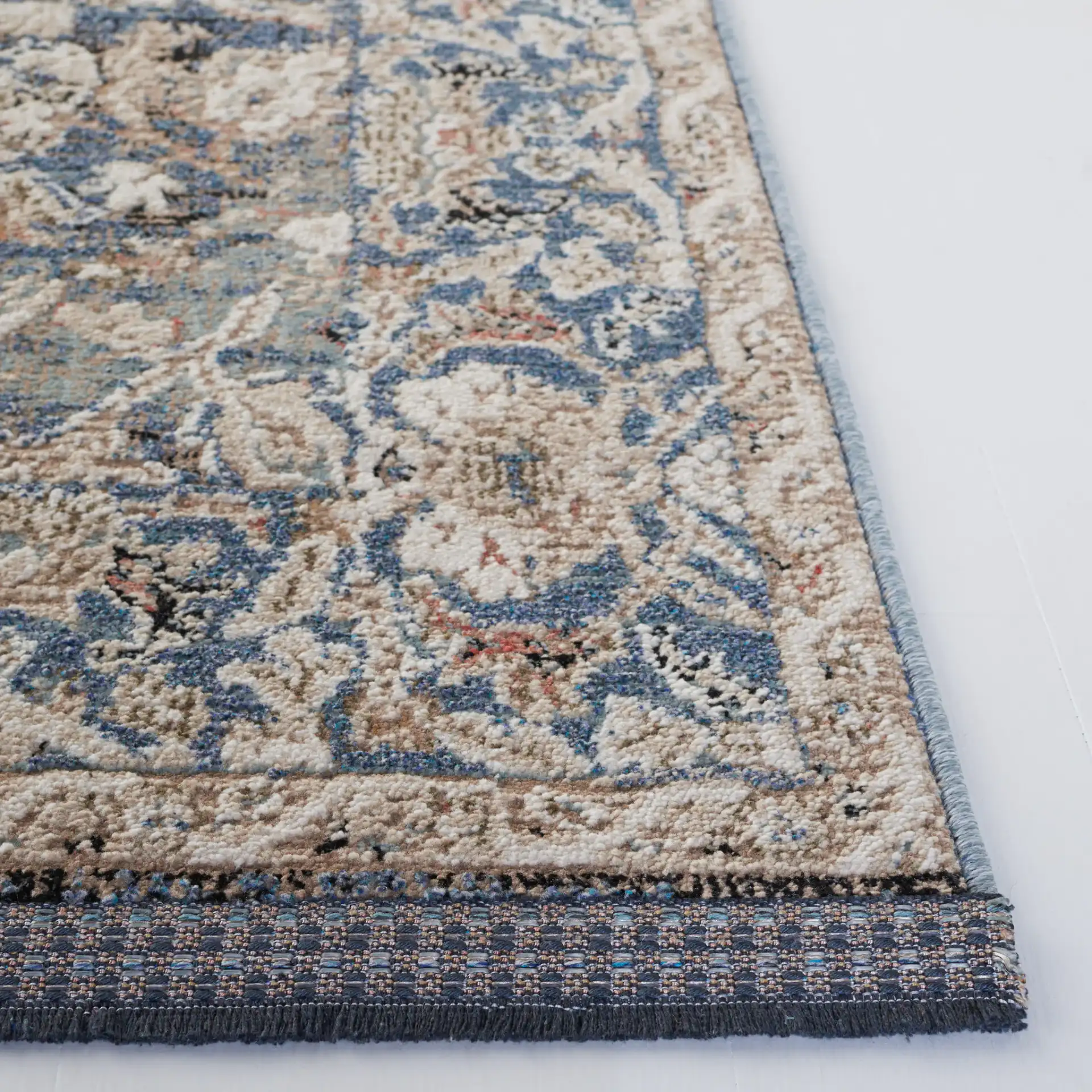 Vivaldi Bordered Floral Rug in Navy / Ivory in a styled room