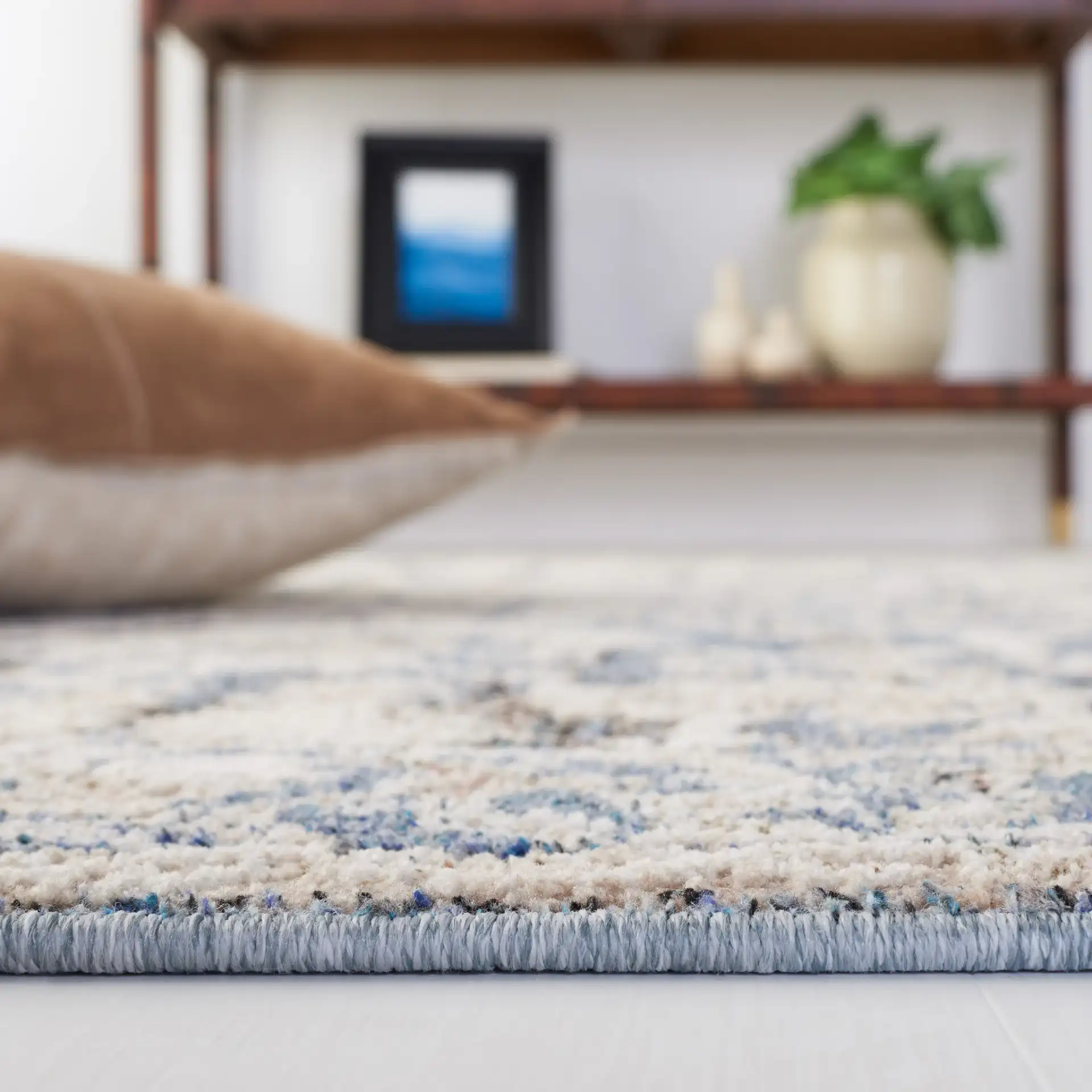 Vivaldi Bordered Floral Rug in Navy / Ivory in a styled room