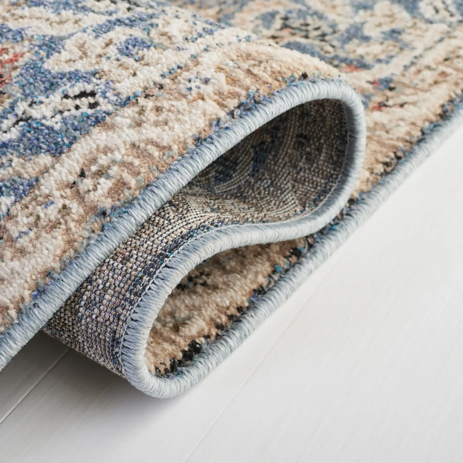 Vivaldi Bordered Floral Rug in Navy / Ivory in a styled room