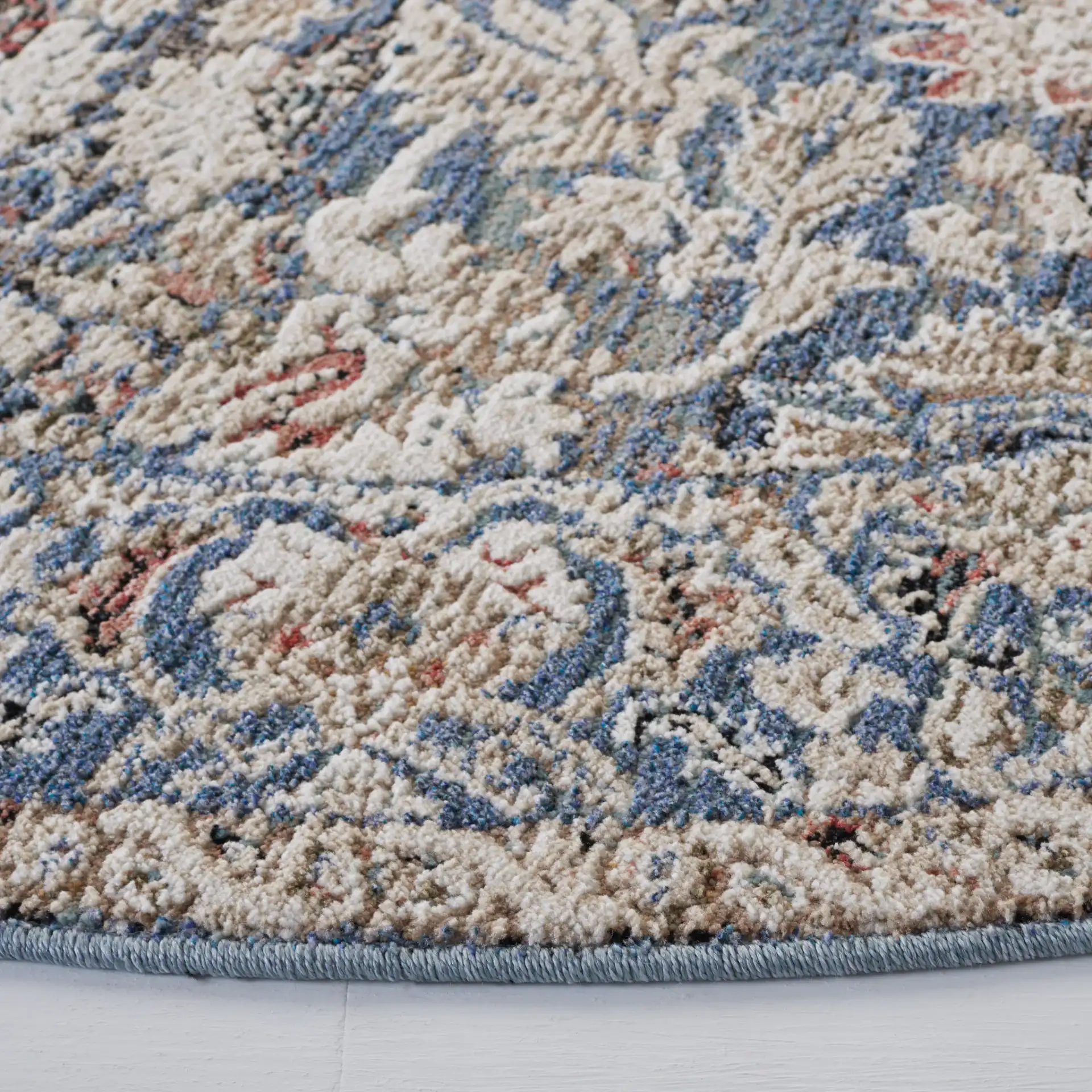 Vivaldi Bordered Floral Rug in Navy / Ivory in a styled room