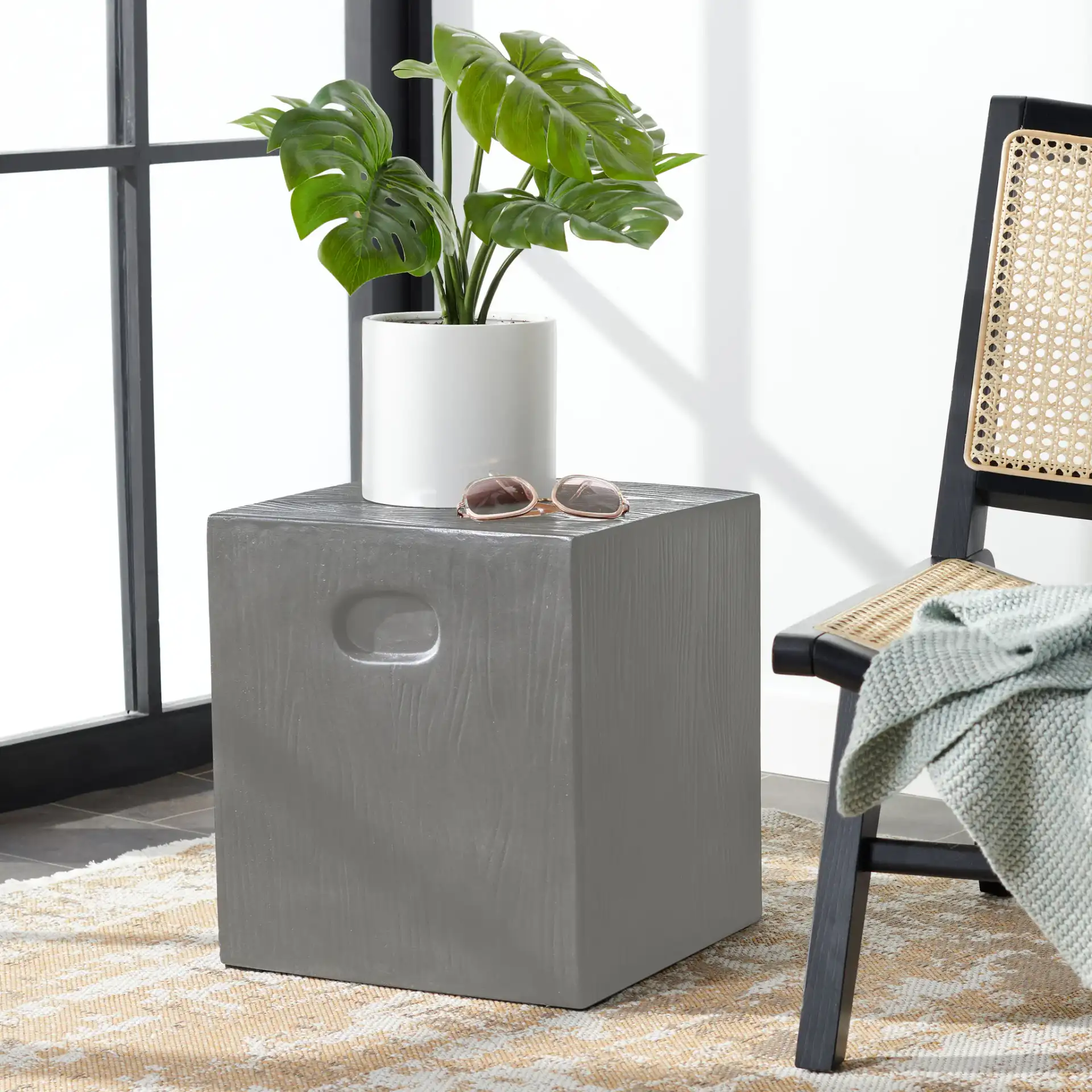 Cube Indoor/Outdoor Accent Stool in Dark Gray in a styled room