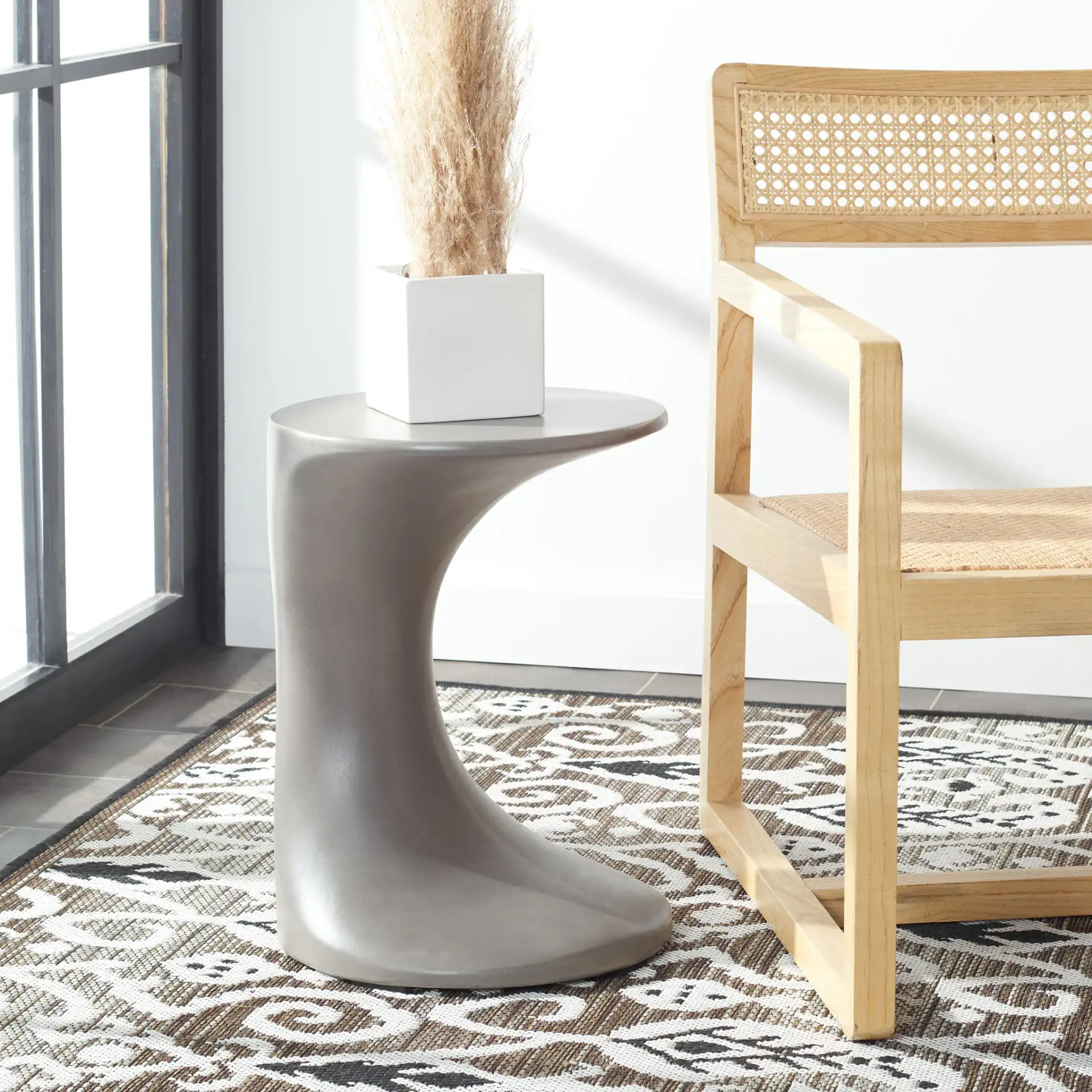 Kavita Concrete Accent Stool in Dark Gray in a styled room