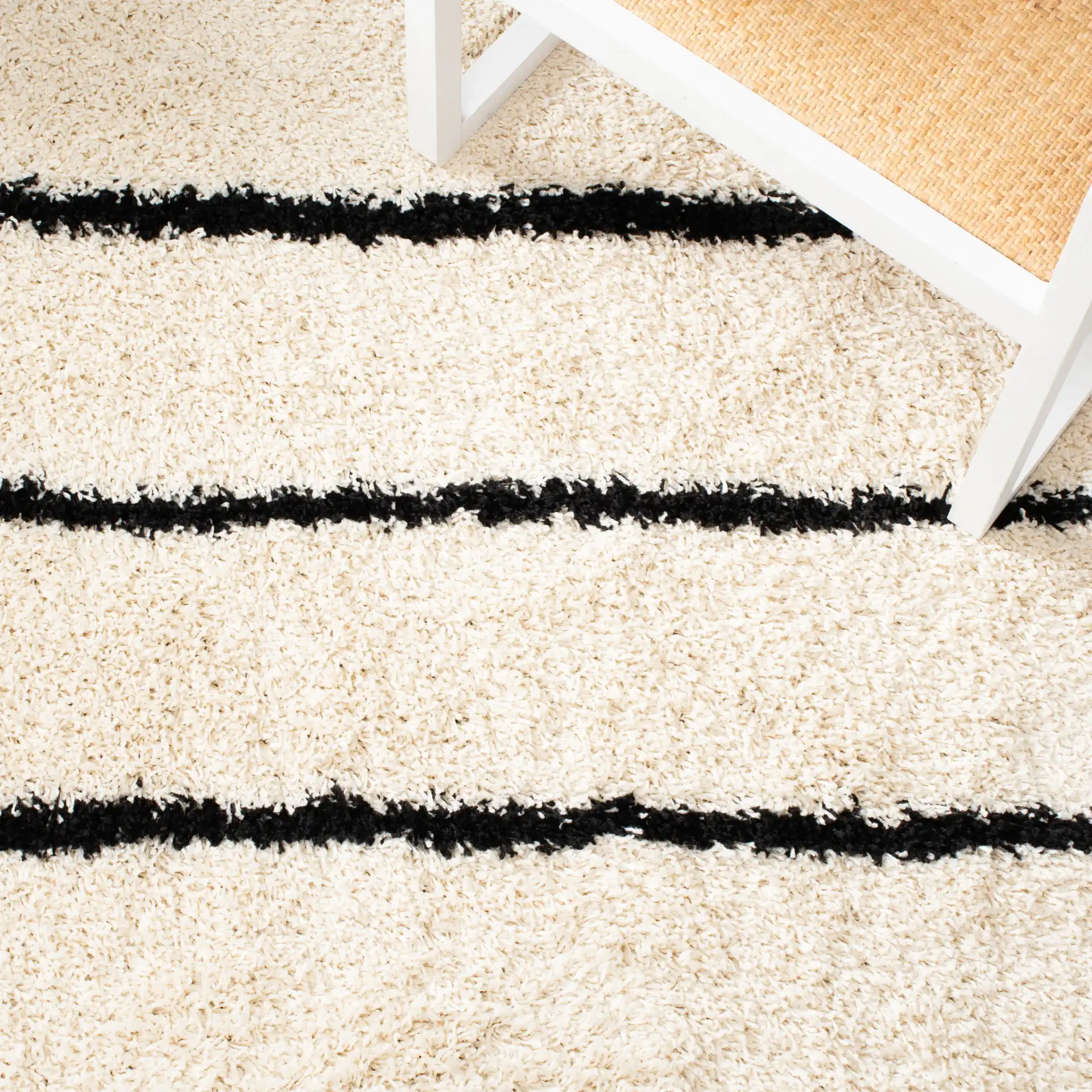 Venus Striped Shag Rug in Ivory / Black in a styled room