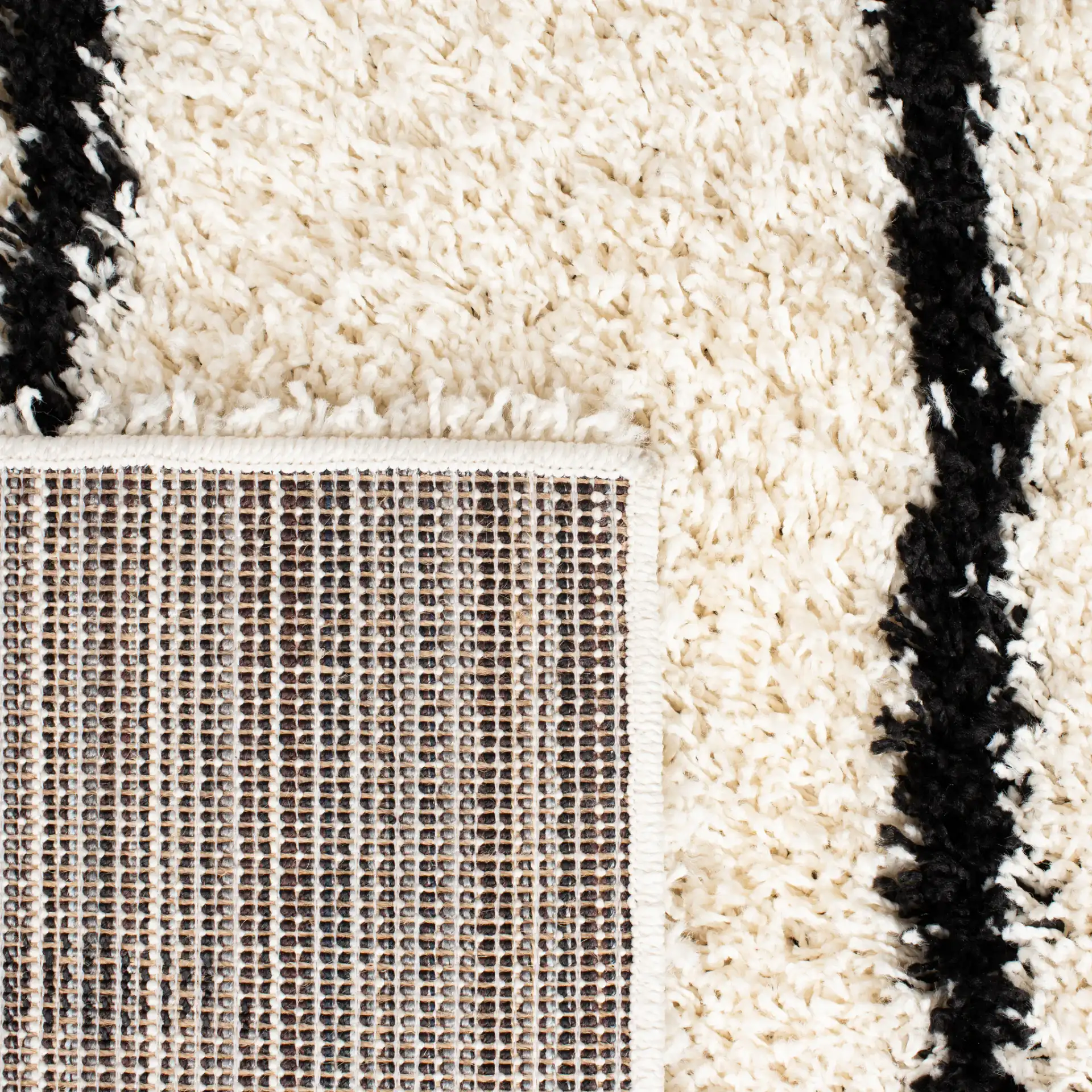 Venus Striped Shag Rug in Ivory / Black in a styled room