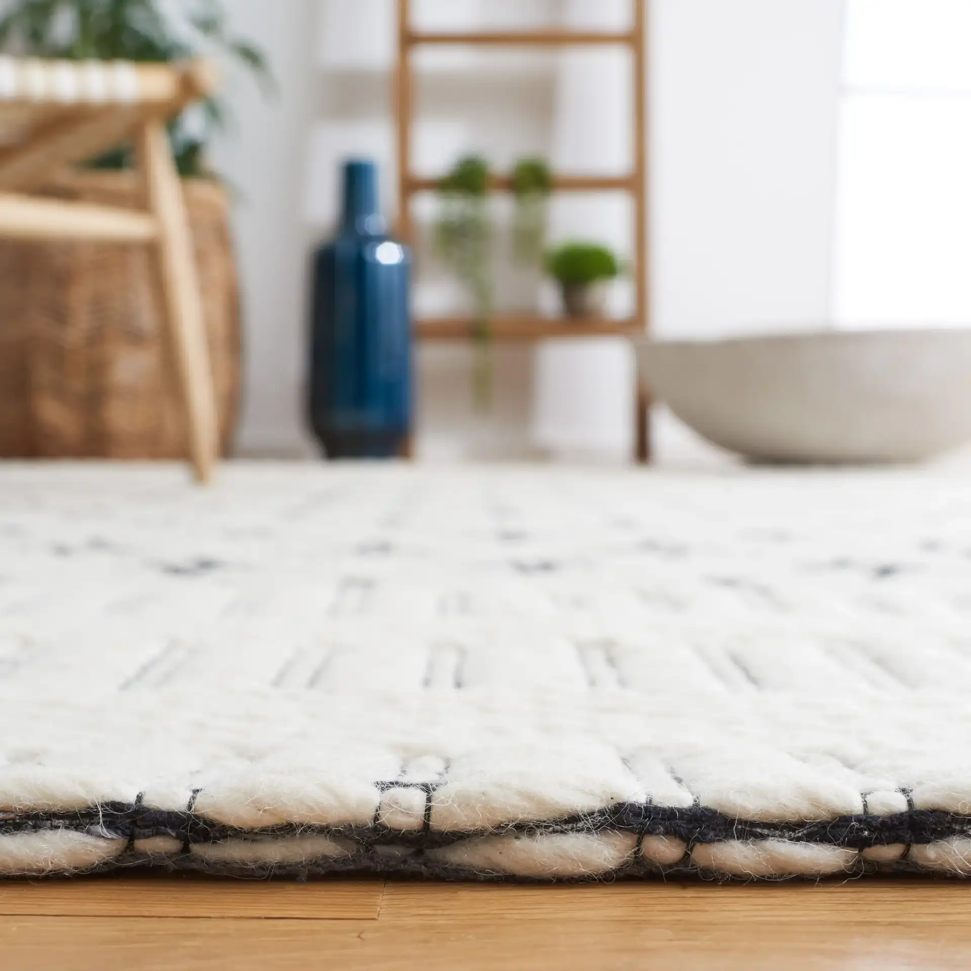 Vermont Stacked Diamond Trellis Hand-Woven Wool Rug in Ivory / Black in a styled room
