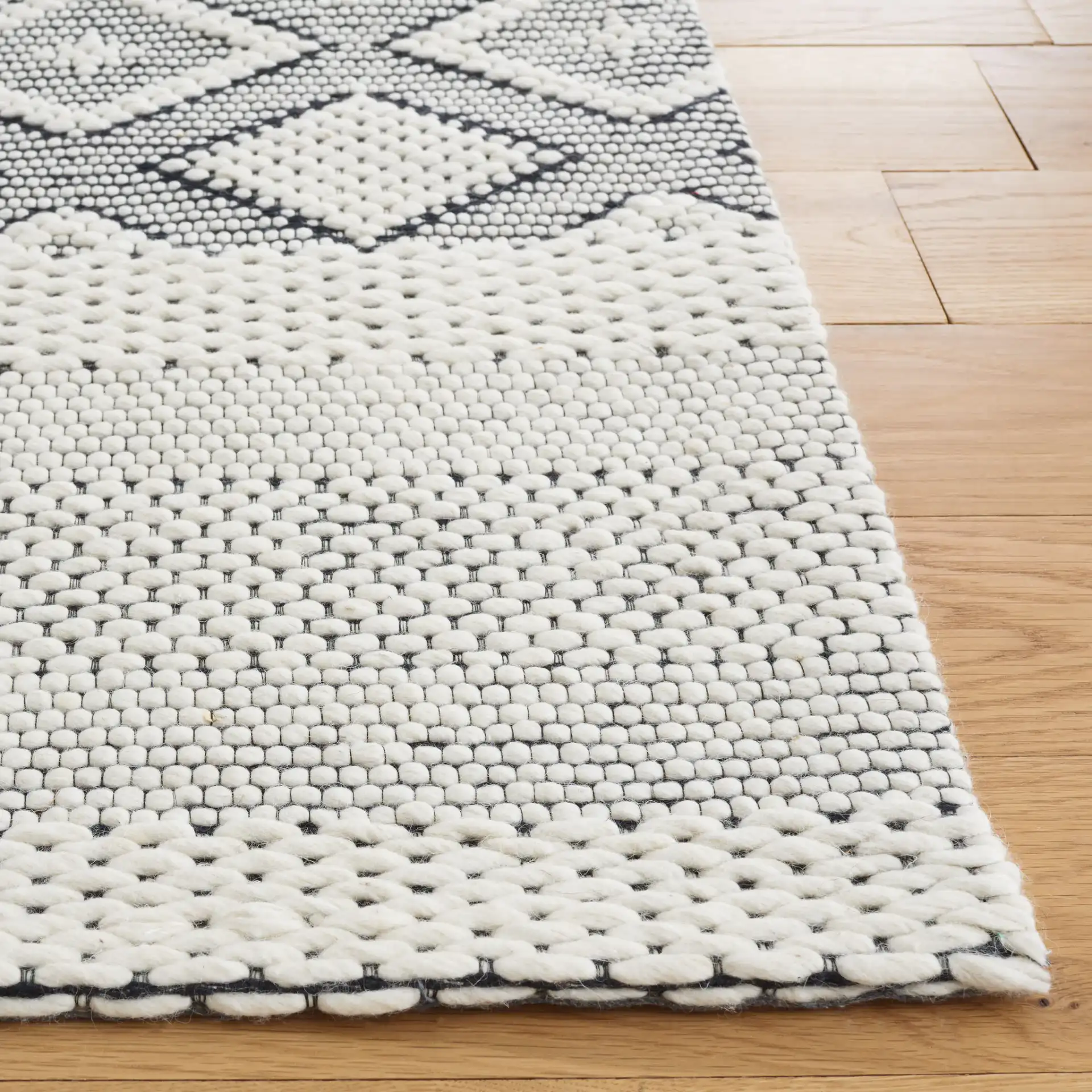Vermont Concentric Diamond Band Hand-Woven Wool Rug in Ivory / Black in a styled room