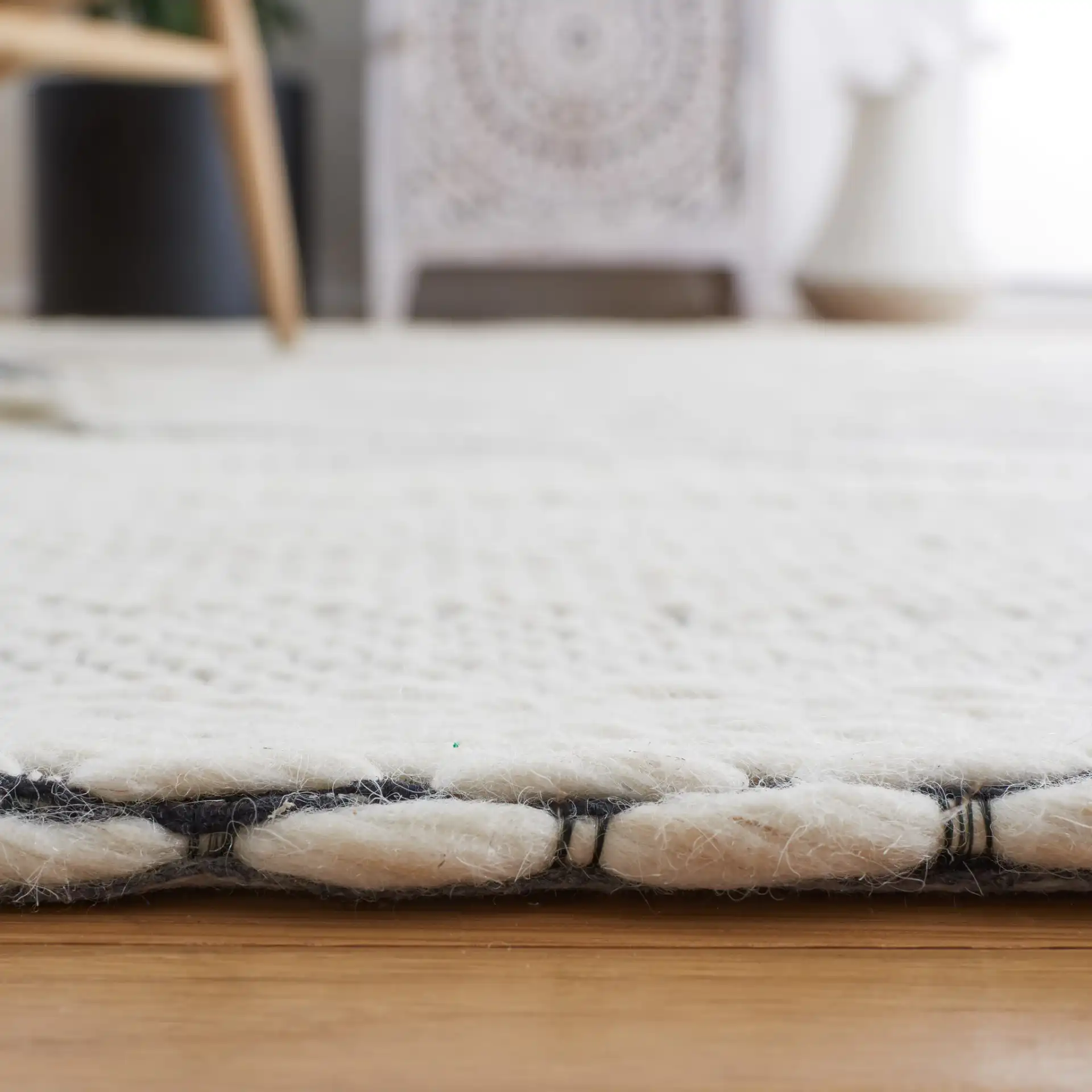 Vermont Concentric Diamond Band Hand-Woven Wool Rug in Ivory / Black in a styled room