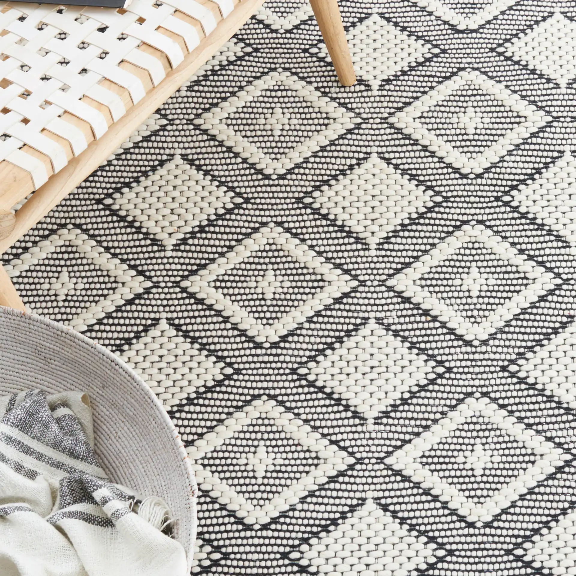 Vermont Concentric Diamond Band Hand-Woven Wool Rug in Ivory / Black in a styled room
