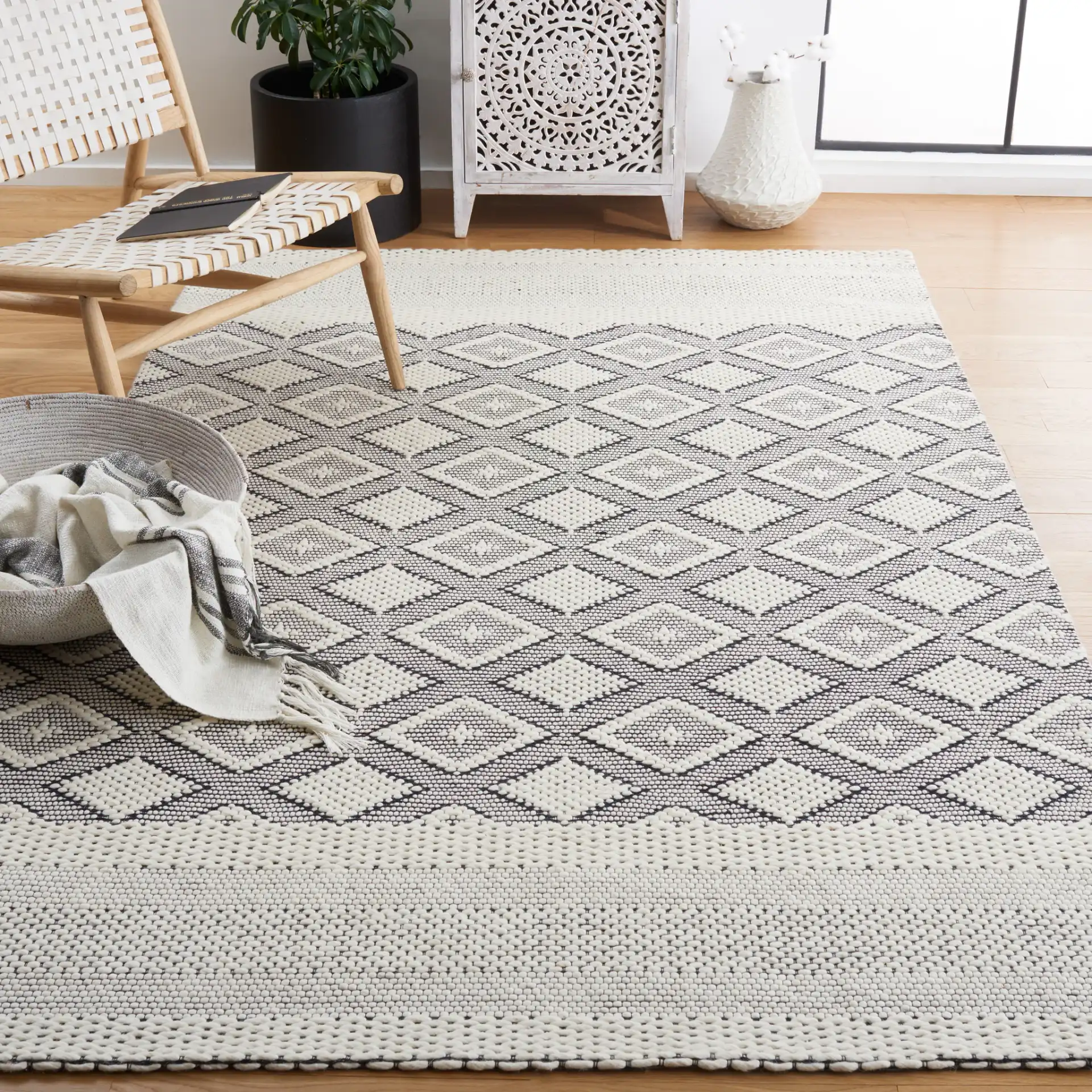 Vermont Concentric Diamond Band Hand-Woven Wool Rug in Ivory / Black in a styled room