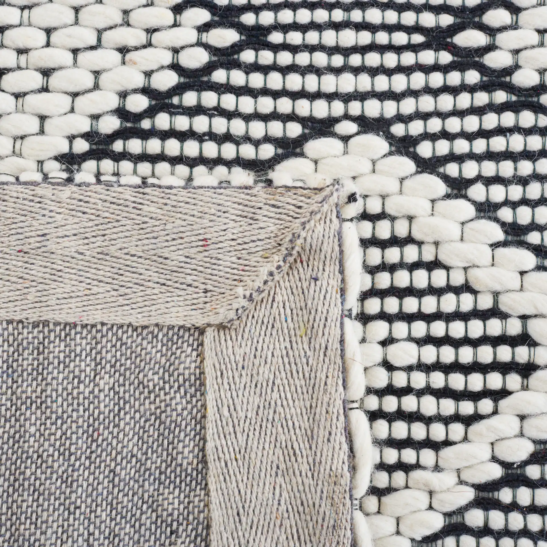 Vermont Concentric Diamond Band Hand-Woven Wool Rug in Ivory / Black in a styled room