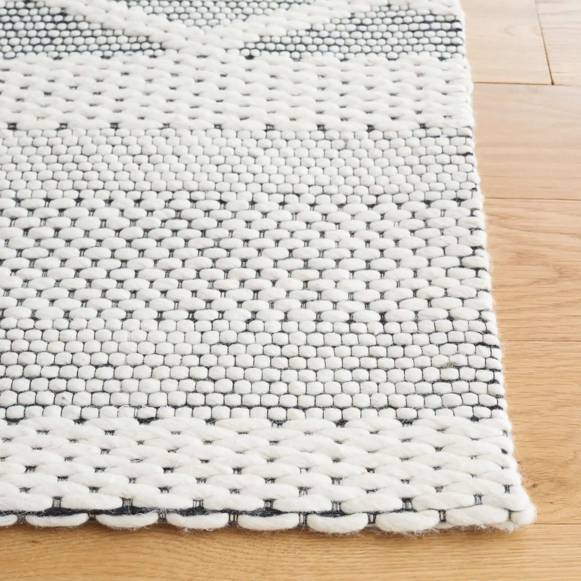 Vermont Lattice Band Hand-Woven Wool Rug in Ivory / Black in a styled room