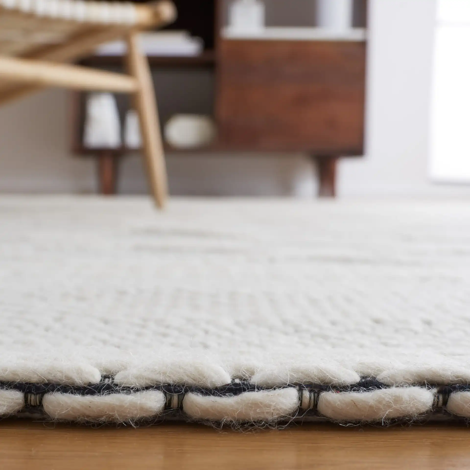 Vermont Lattice Band Hand-Woven Wool Rug in Ivory / Black in a styled room