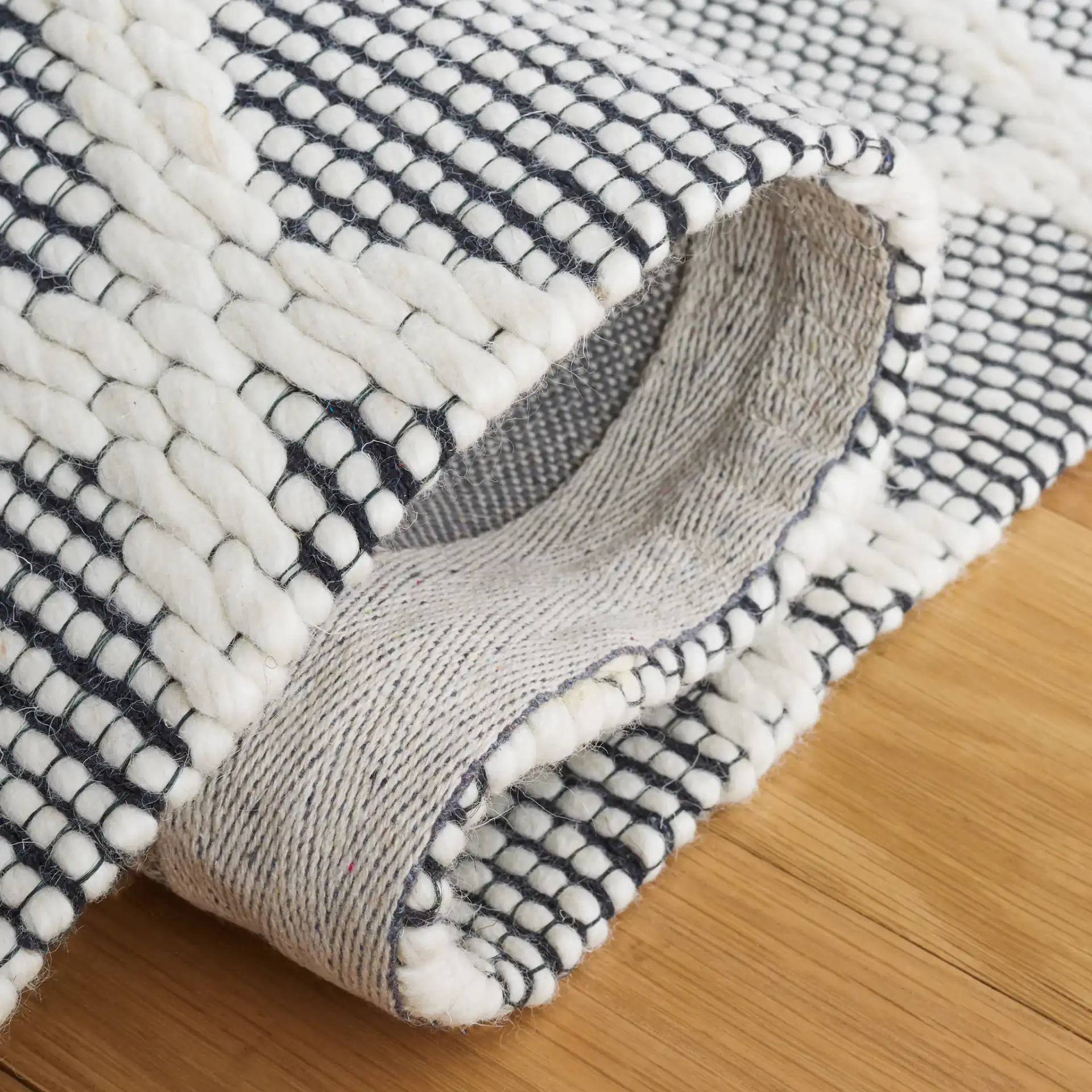 Vermont Lattice Band Hand-Woven Wool Rug in Ivory / Black in a styled room