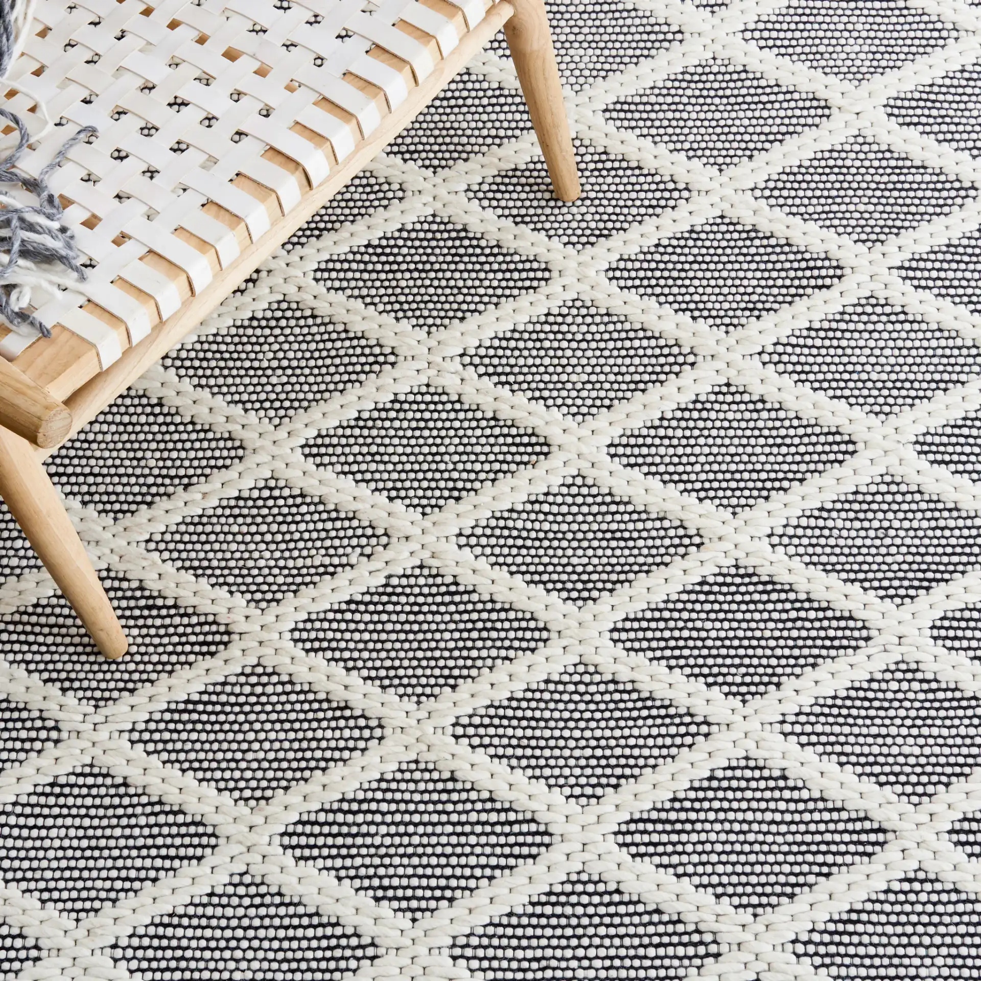 Vermont Lattice Band Hand-Woven Wool Rug in Ivory / Black in a styled room