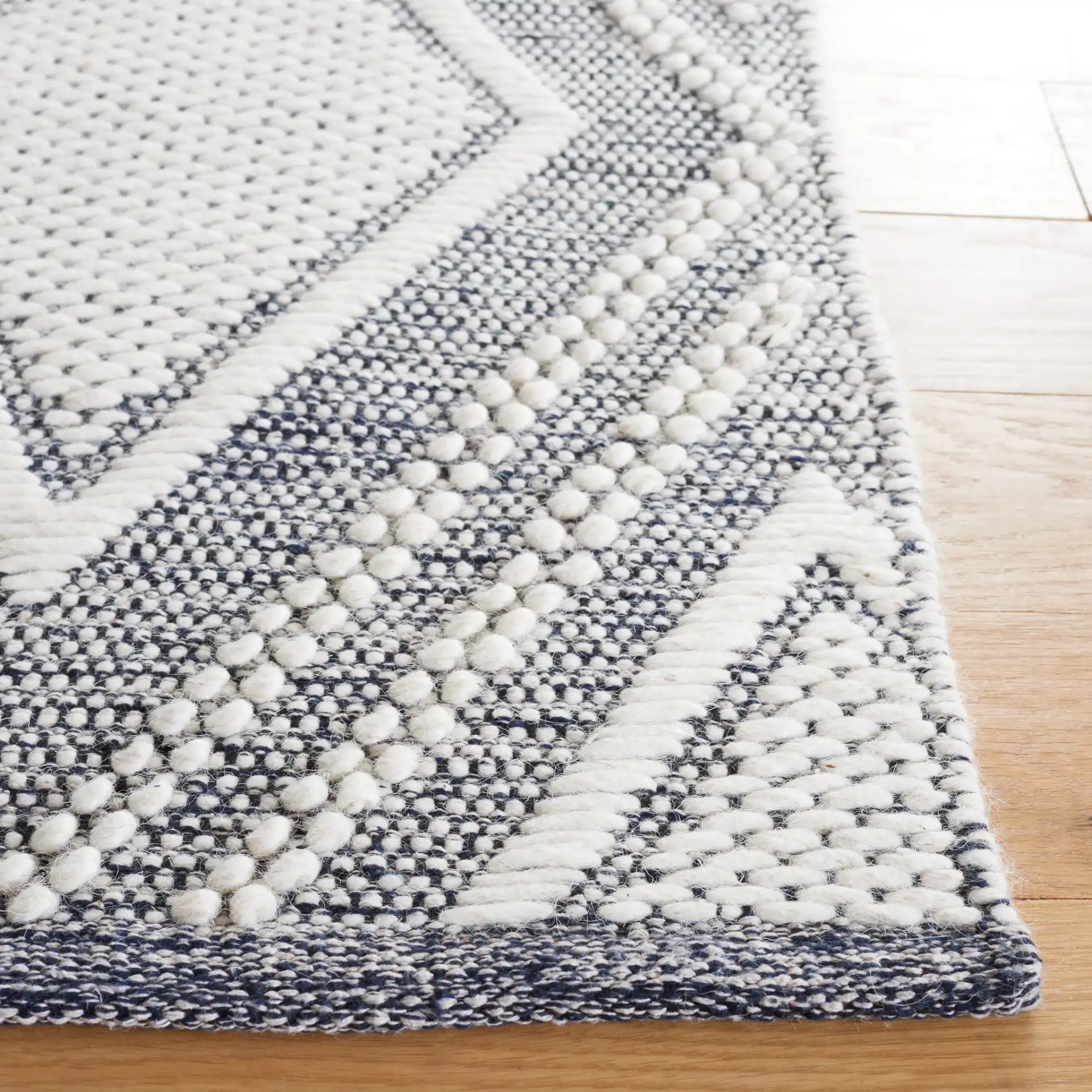 Vermont Nested Diamond Hand-Woven Wool Rug in Ivory / Navy in a styled room