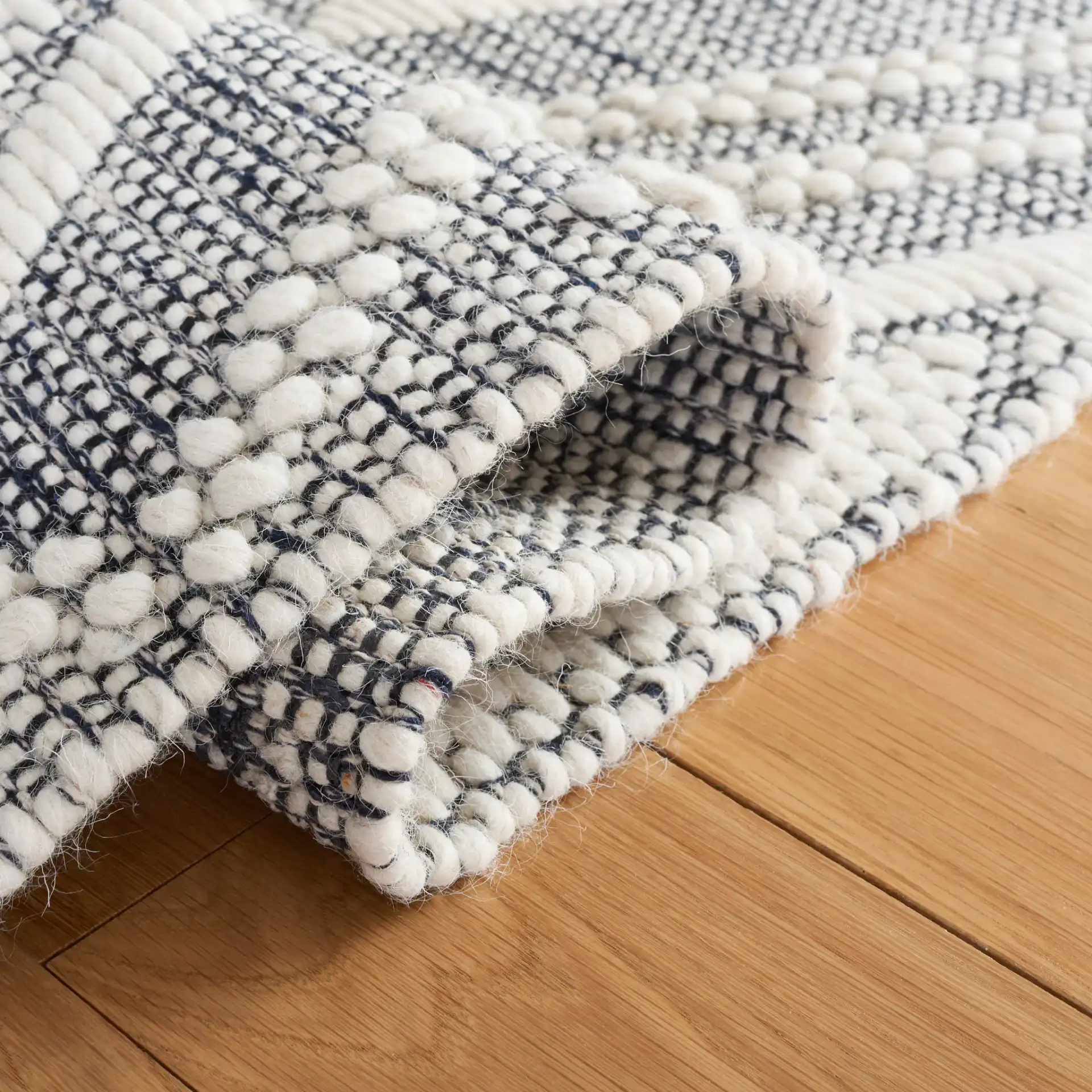 Vermont Nested Diamond Hand-Woven Wool Rug in Ivory / Navy in a styled room