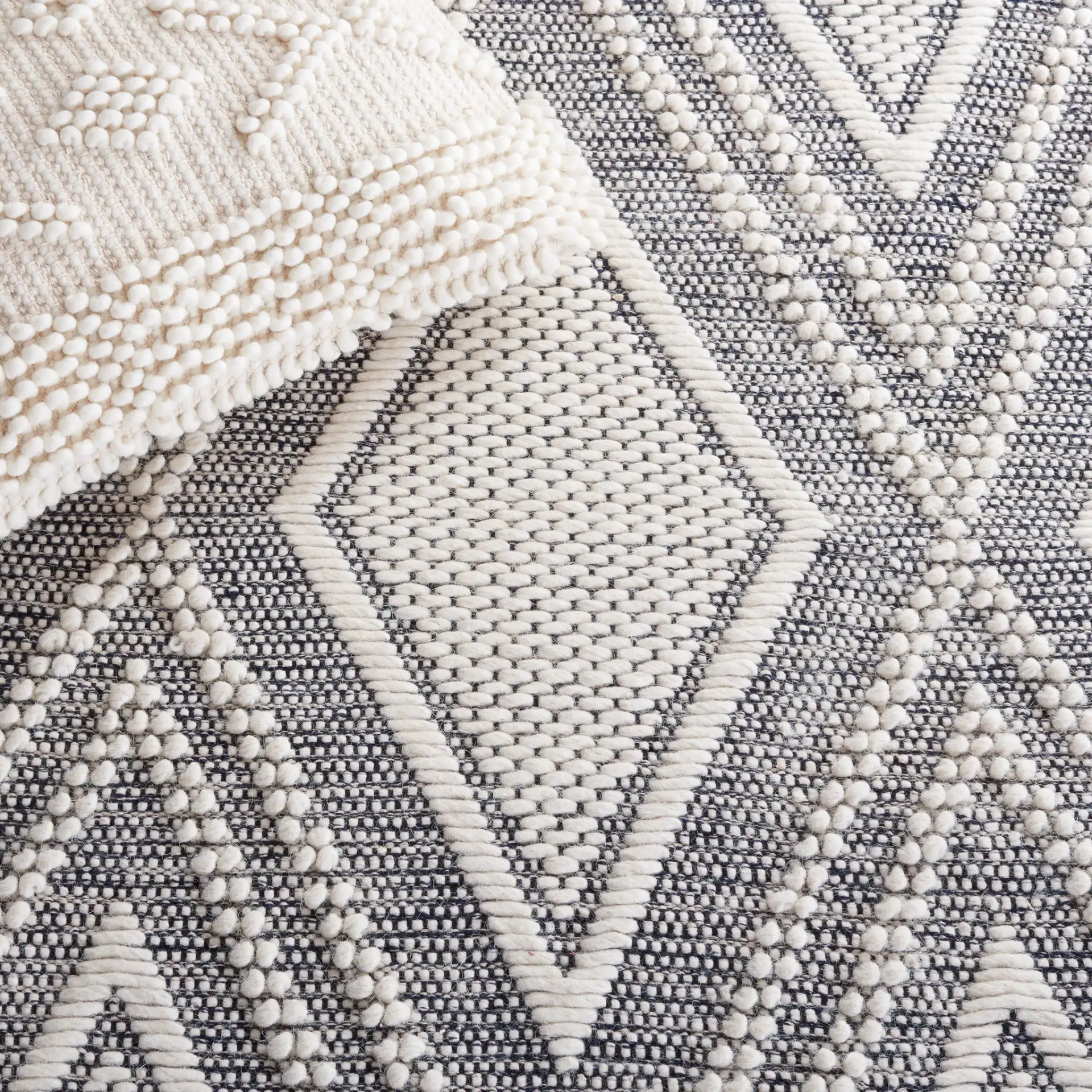 Vermont Nested Diamond Hand-Woven Wool Rug in Ivory / Navy in a styled room