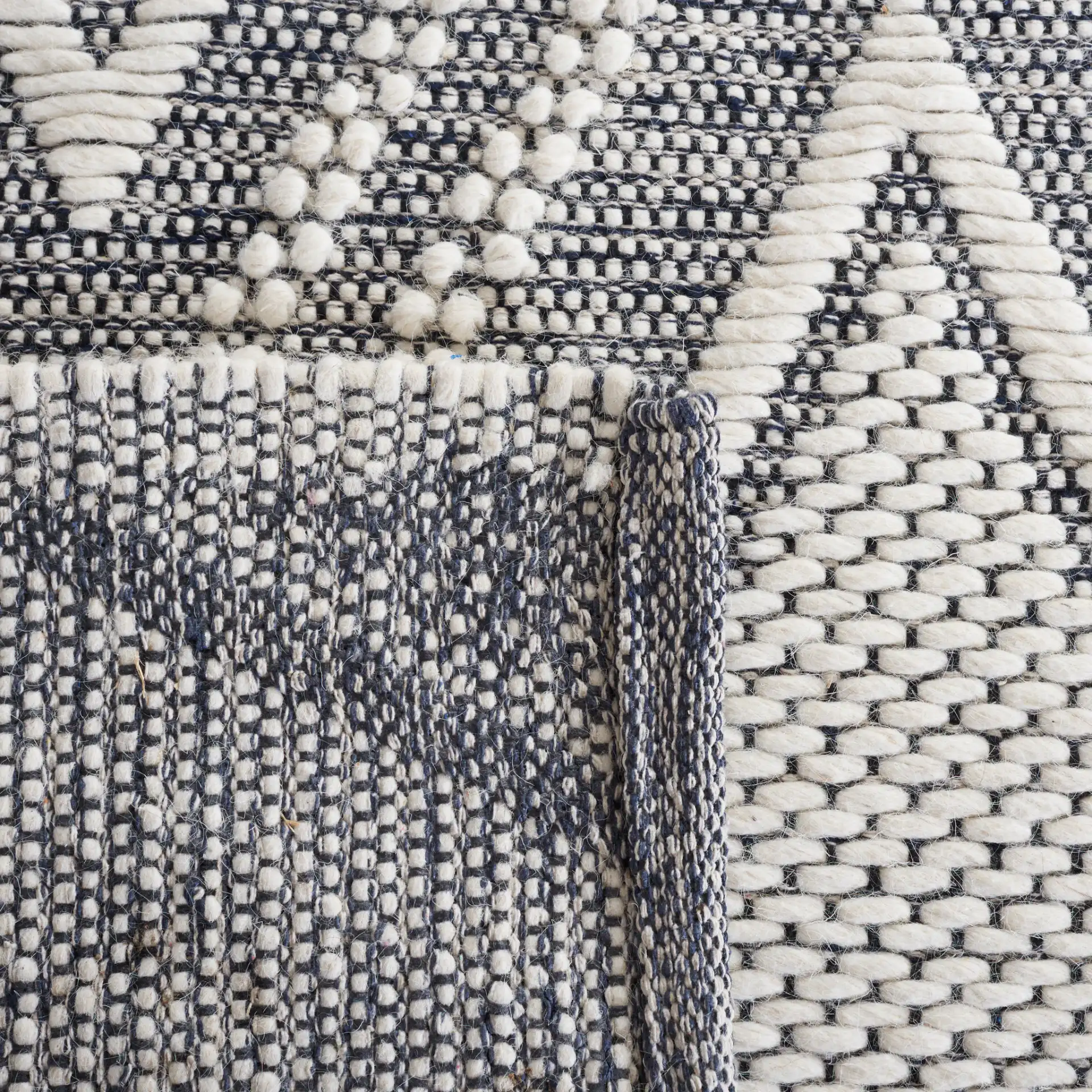 Vermont Nested Diamond Hand-Woven Wool Rug in Ivory / Navy in a styled room