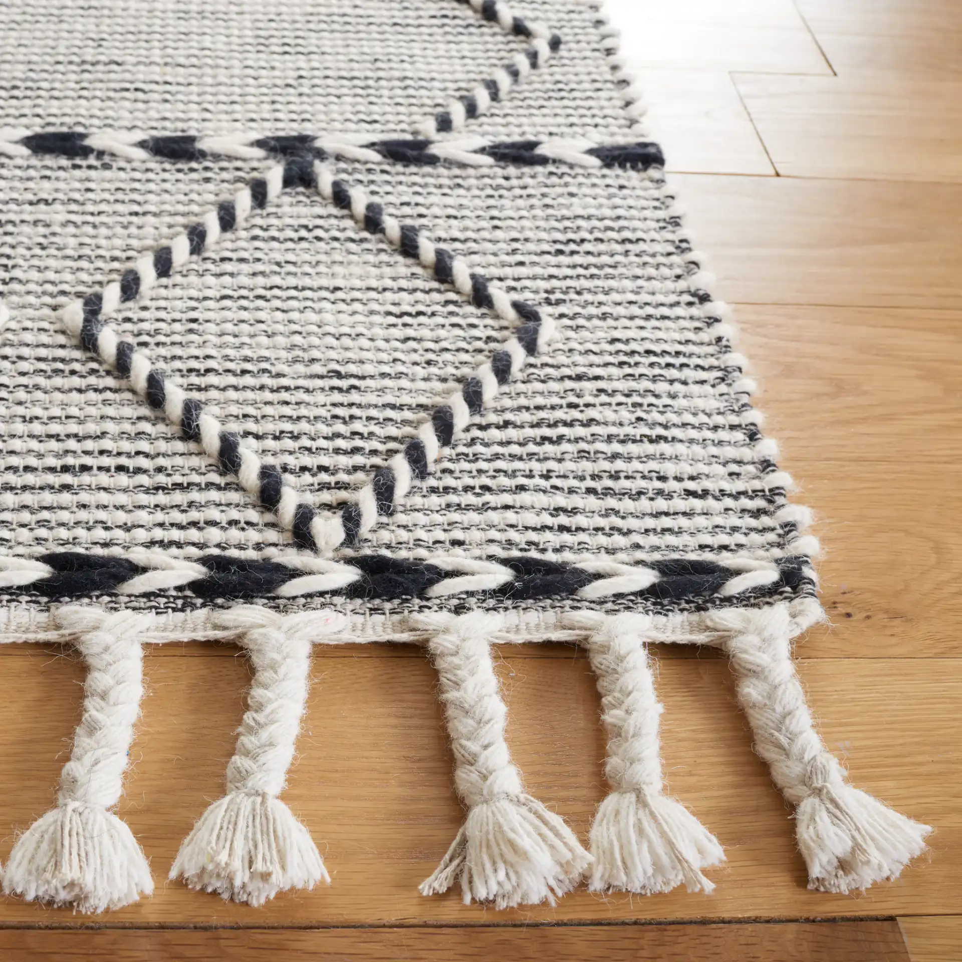 Vermont Large Diamond Hand-Woven Wool Rug in Ivory / Black in a styled room