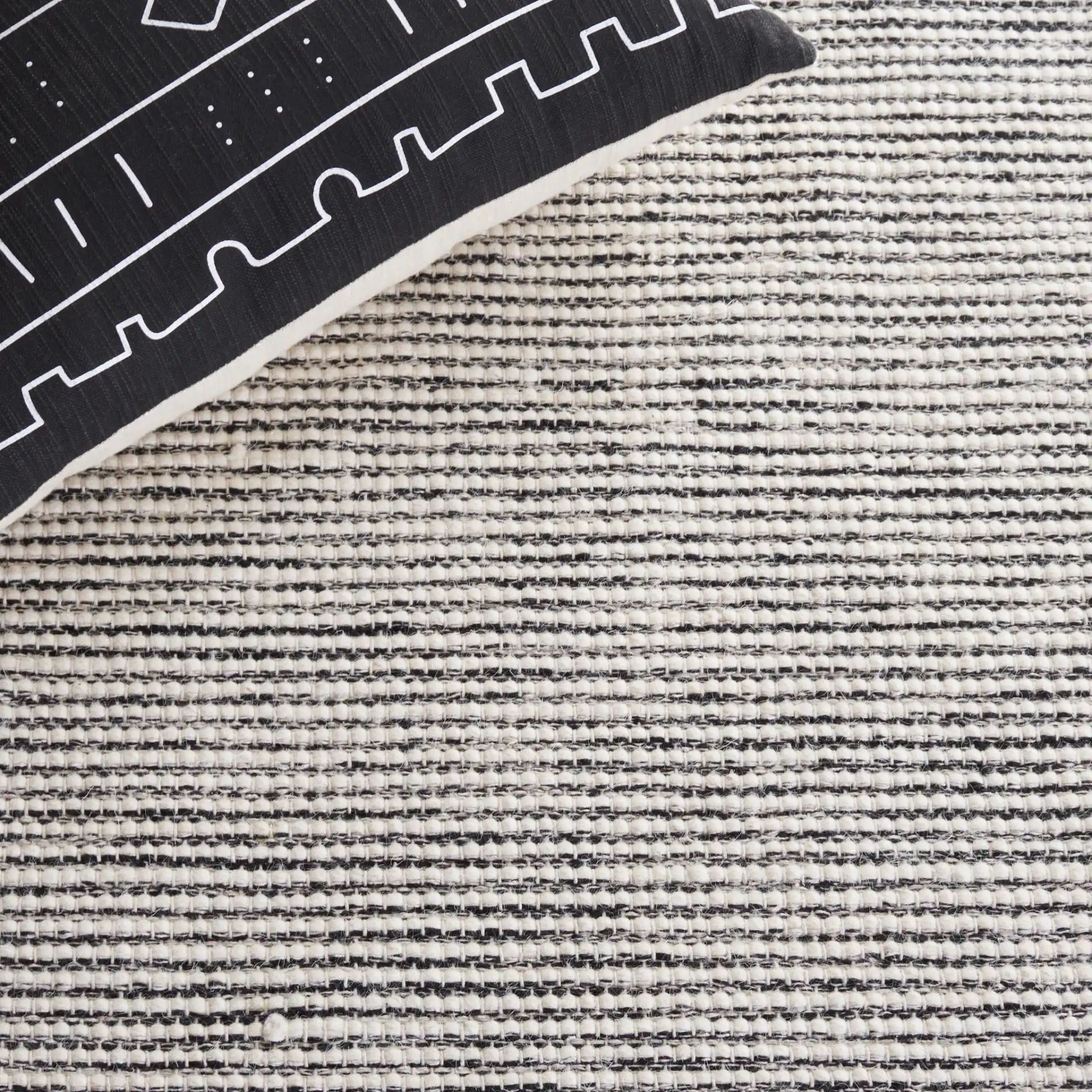 Vermont Large Diamond Hand-Woven Wool Rug in Ivory / Black in a styled room