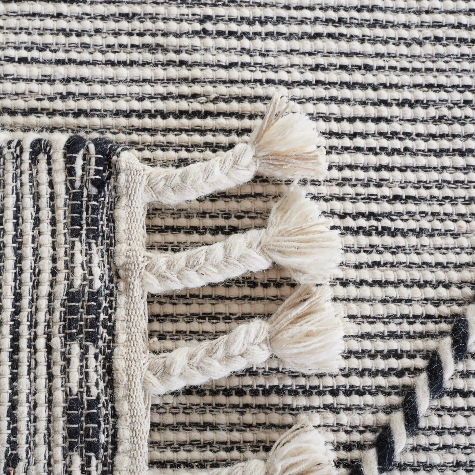 Vermont Large Diamond Hand-Woven Wool Rug in Ivory / Black in a styled room
