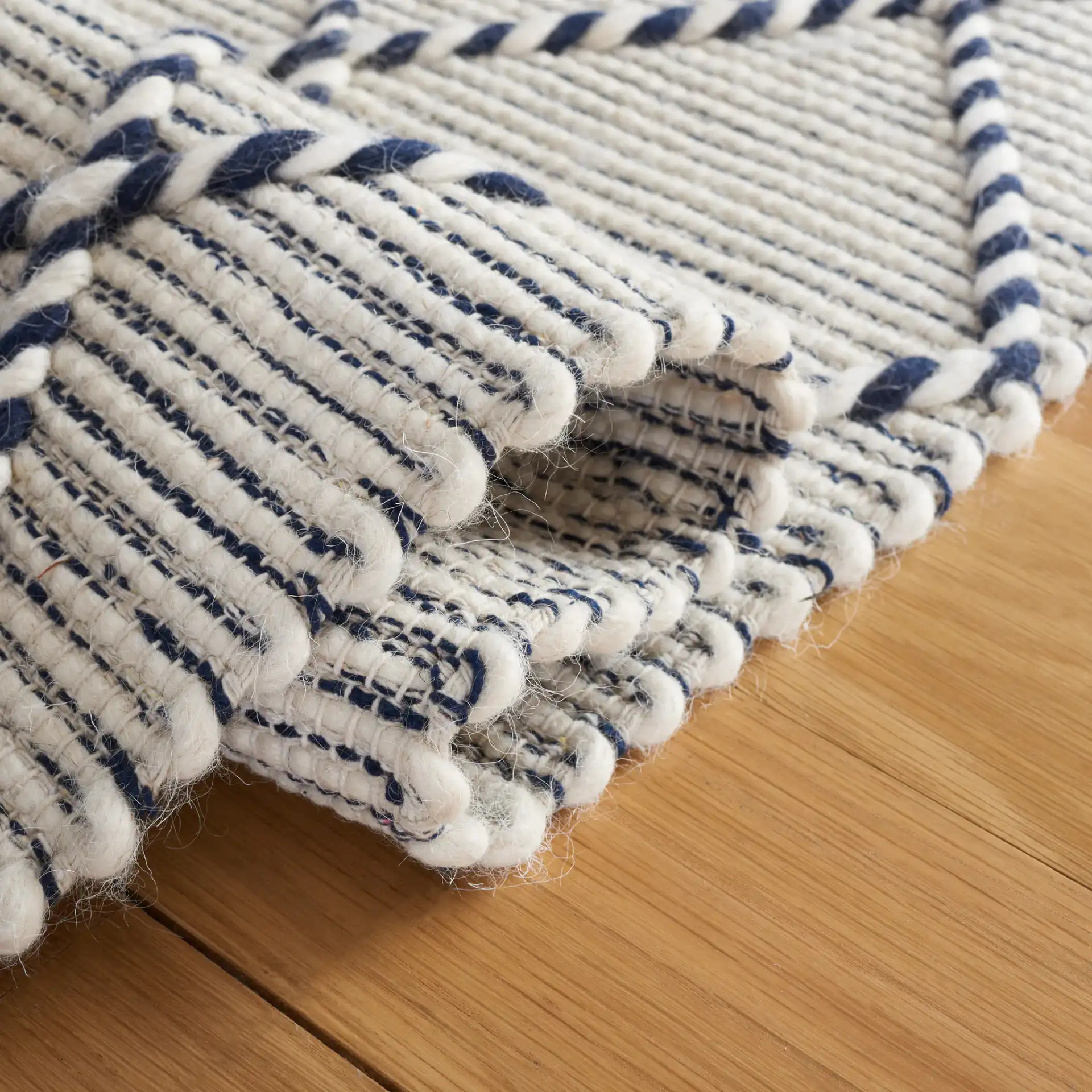 Vermont Moroccan Diamond Hand-Woven Wool Rug in Ivory / Navy in a styled room