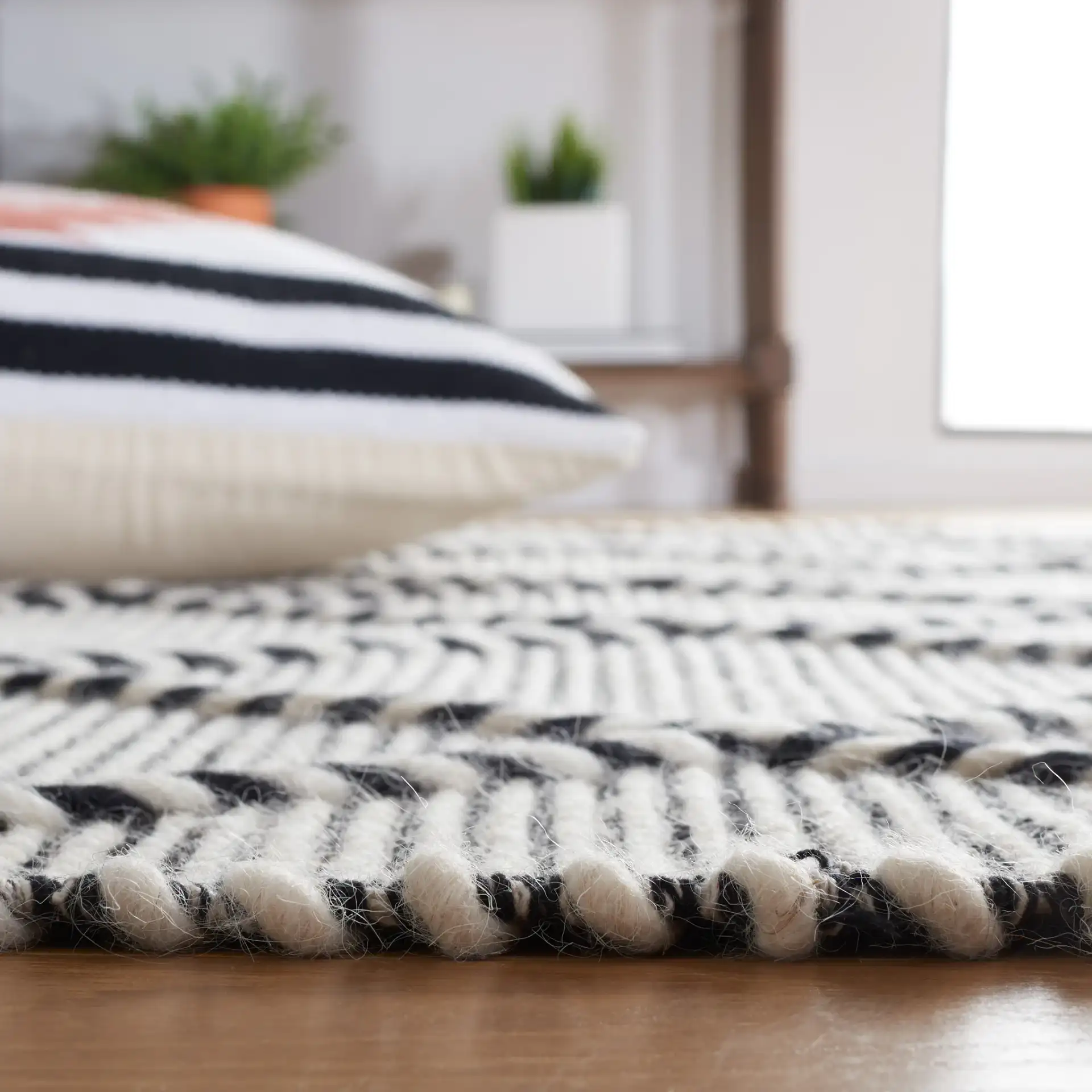 Vermont Thin Diamond Trellis Hand-Woven Wool Rug in Ivory / Black in a styled room