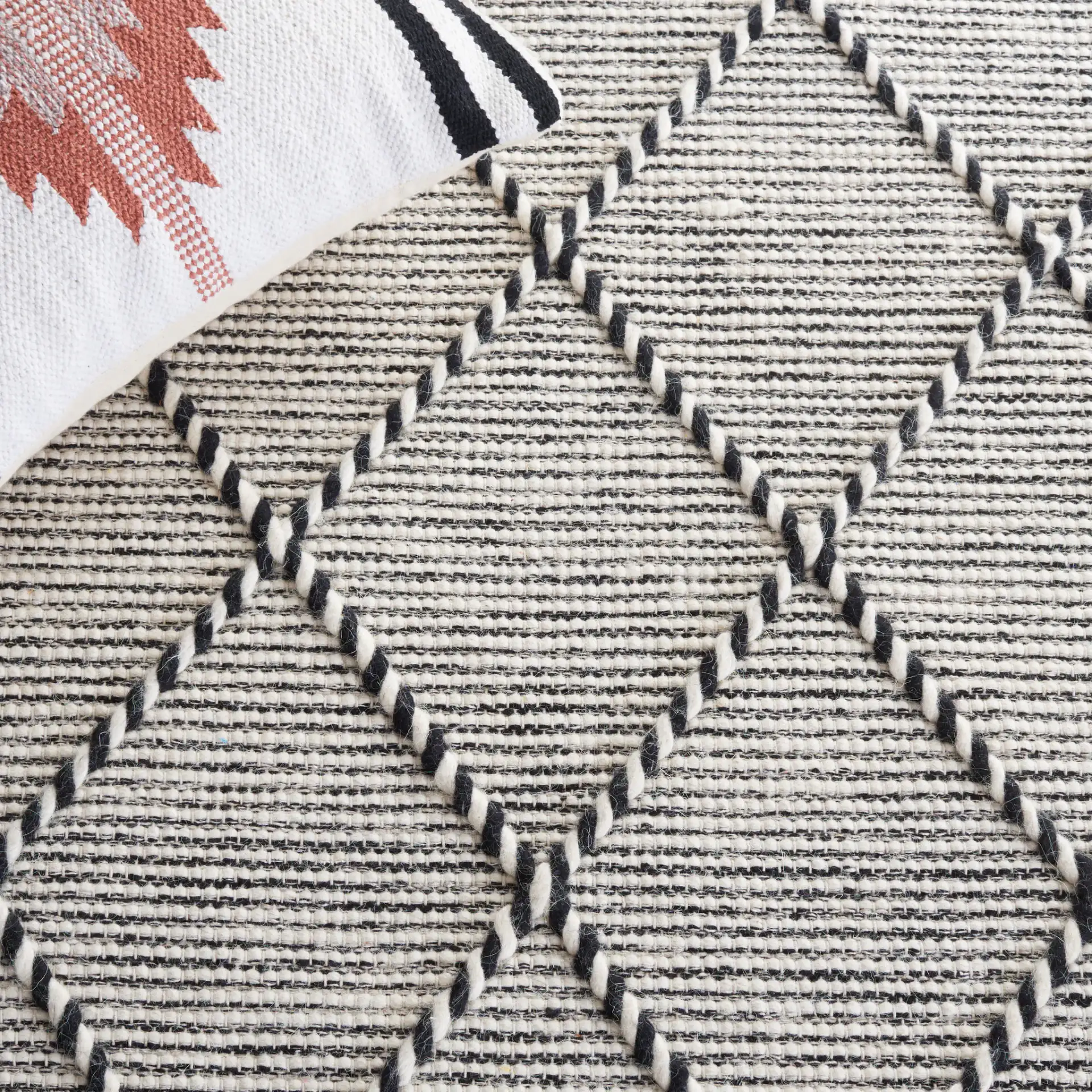 Vermont Thin Diamond Trellis Hand-Woven Wool Rug in Ivory / Black in a styled room