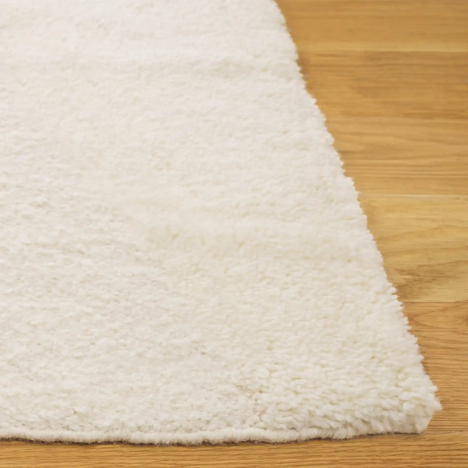 Vermont Abstract Wave Hand-Woven Wool Rug in Ivory in a styled room