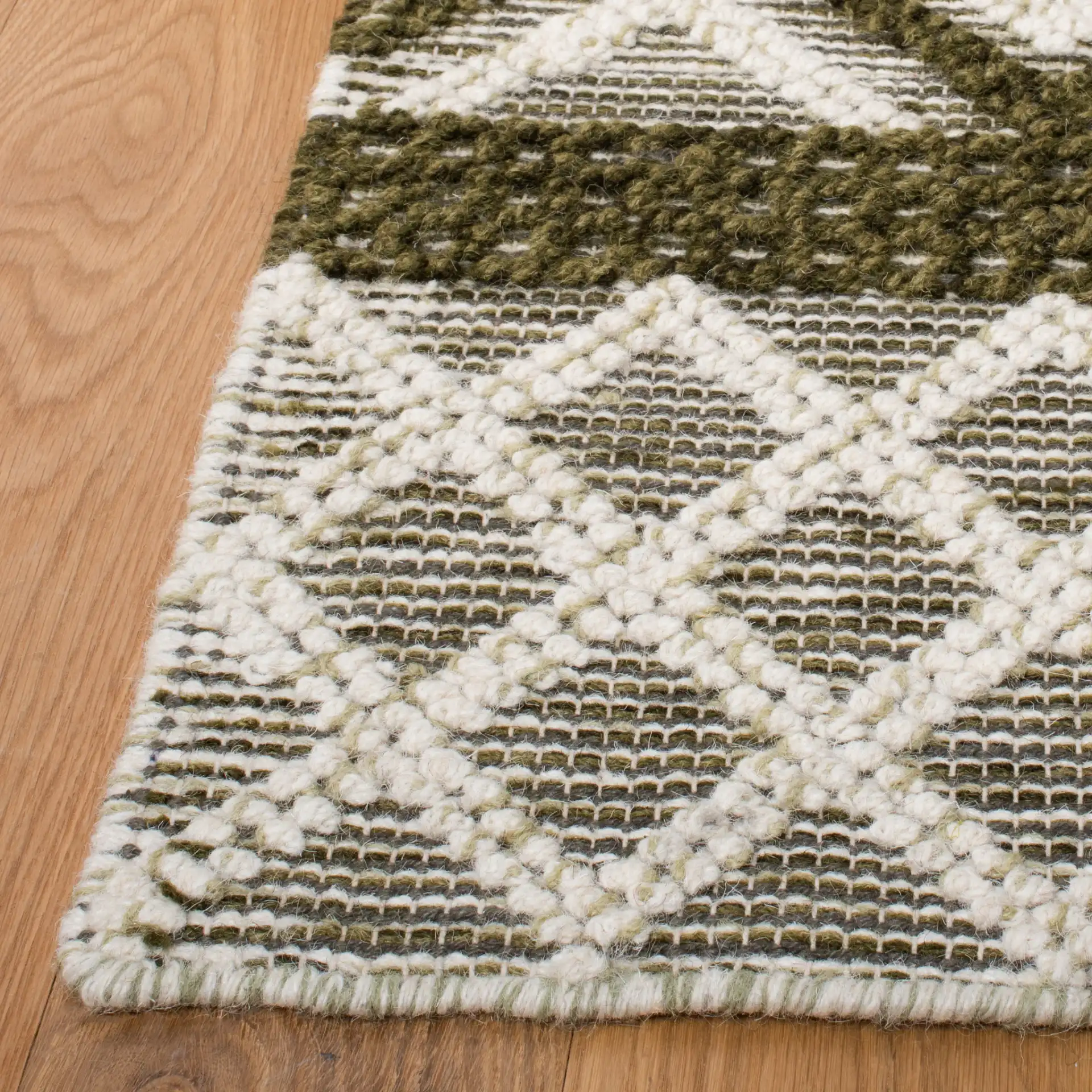 Vermont Banded Diamond Hand-Woven Wool and Cotton Rug in Ivory / Dark Green in a styled room