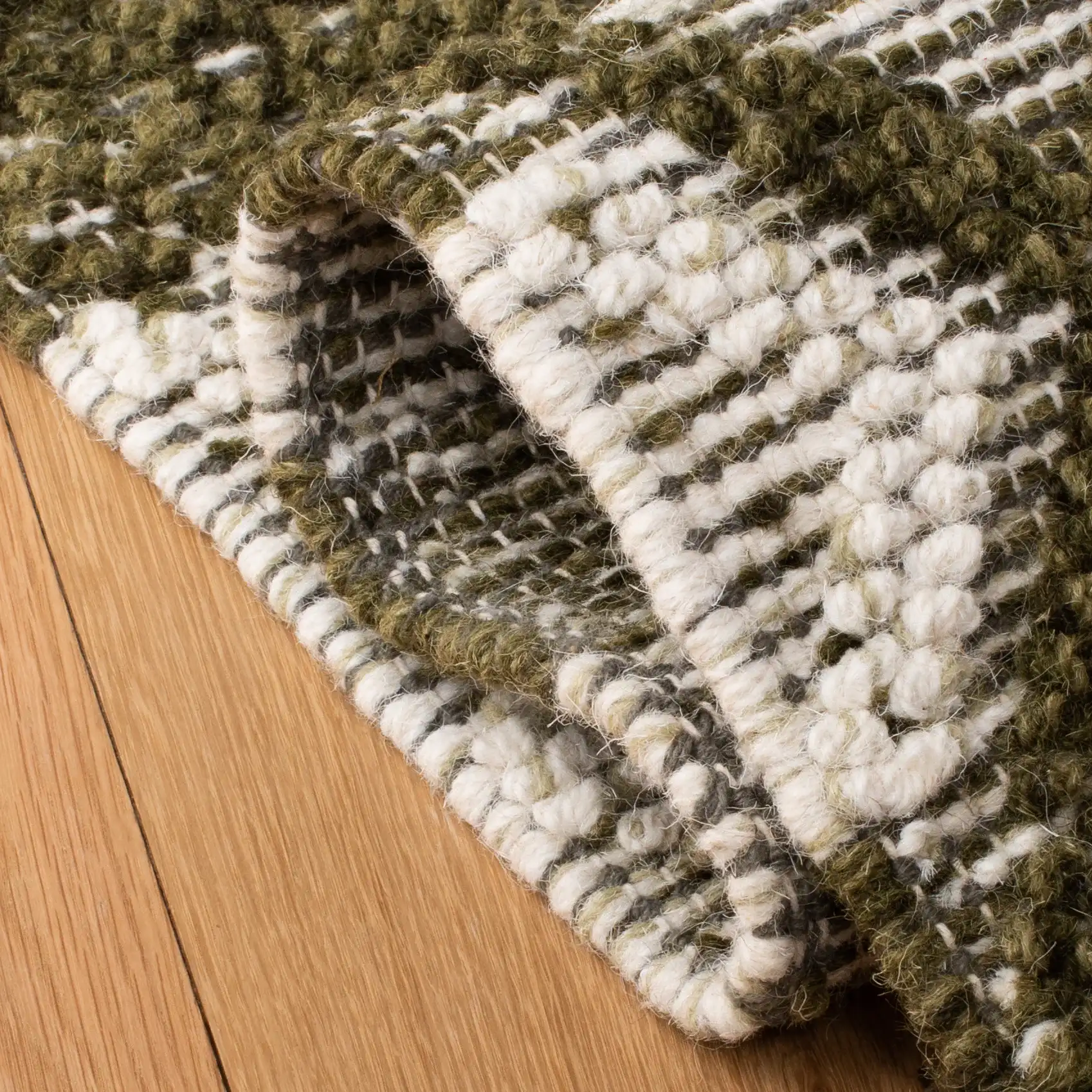 Vermont Banded Diamond Hand-Woven Wool and Cotton Rug in Ivory / Dark Green in a styled room