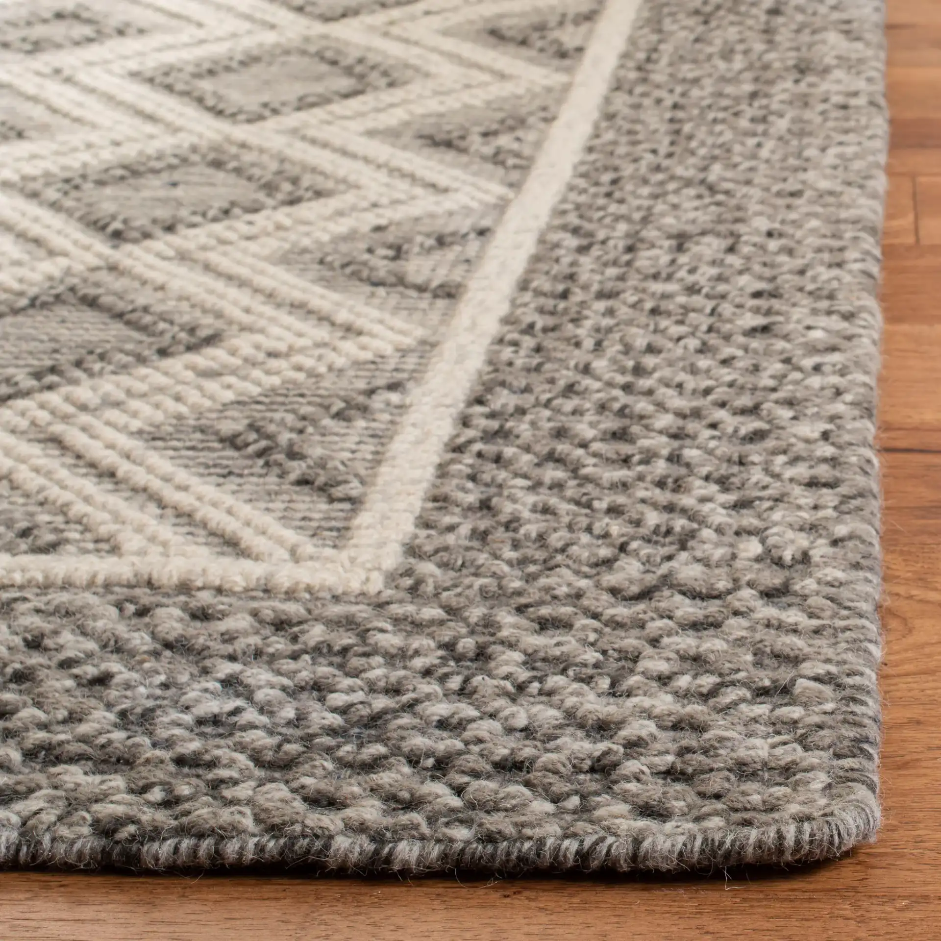 Vermont Diamond Border Hand-Woven Rug in Gray / Ivory in a styled room