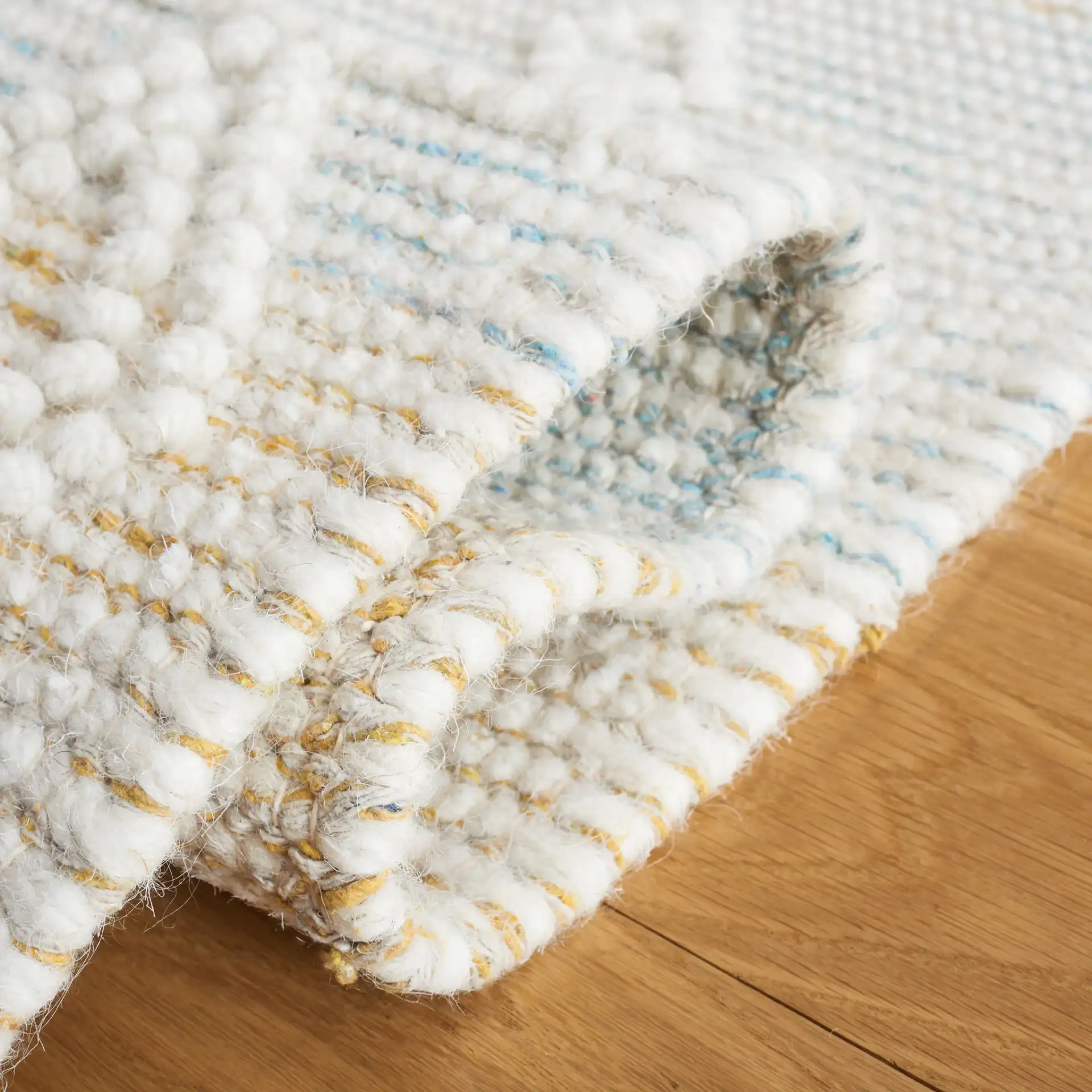 Vermont Fjord Diamond Hand-Loomed Wool Rug in Light Blue / Yellow in a styled room