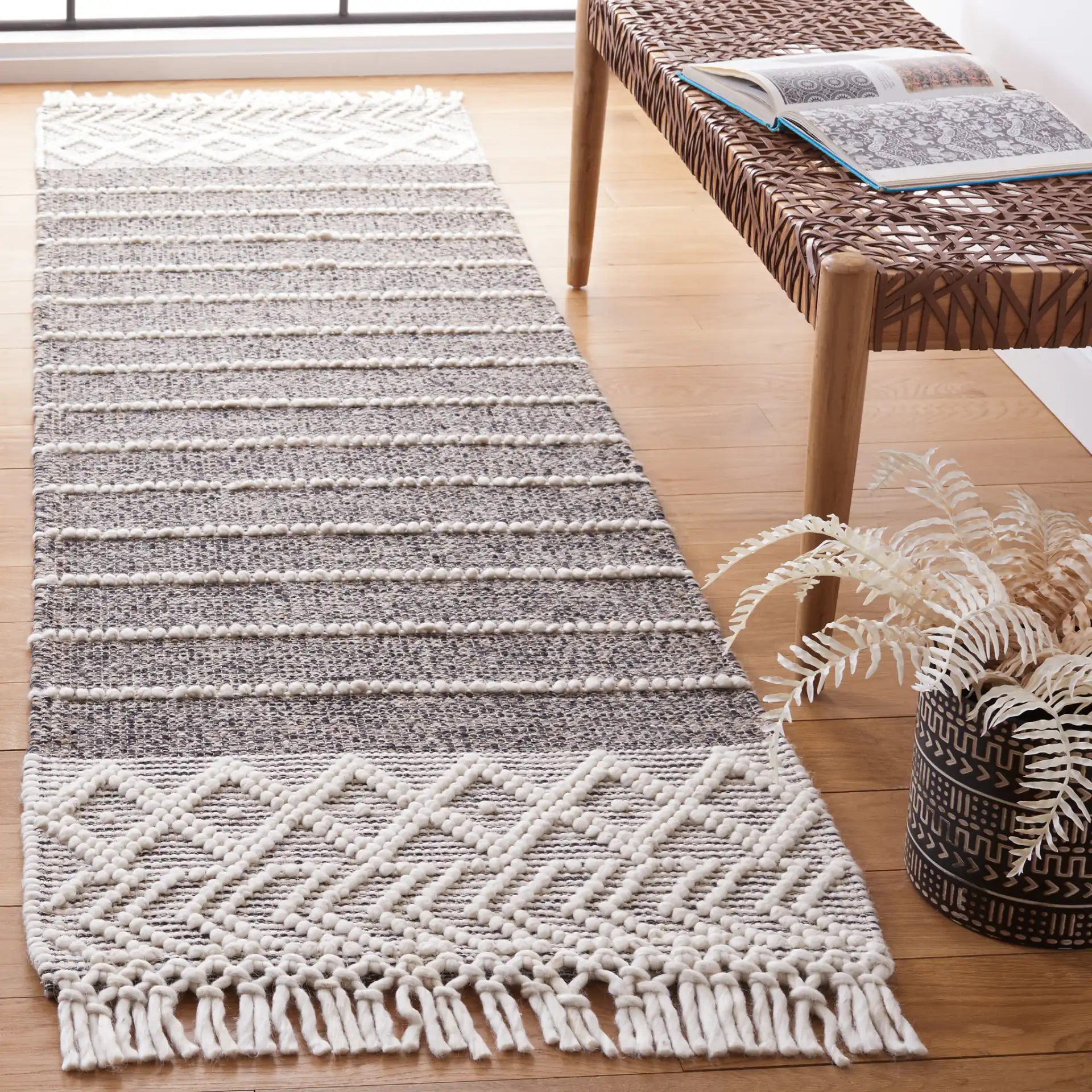 Vermont Striped Chevron Hand-Loomed Wool Rug in Black / Ivory in a styled room