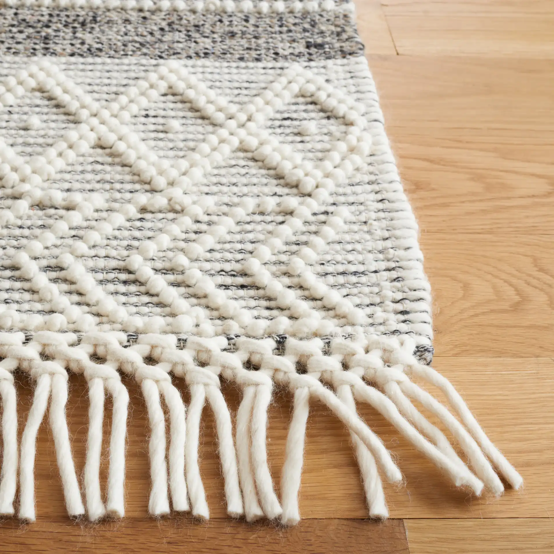 Vermont Striped Chevron Hand-Loomed Wool Rug in Black / Ivory in a styled room